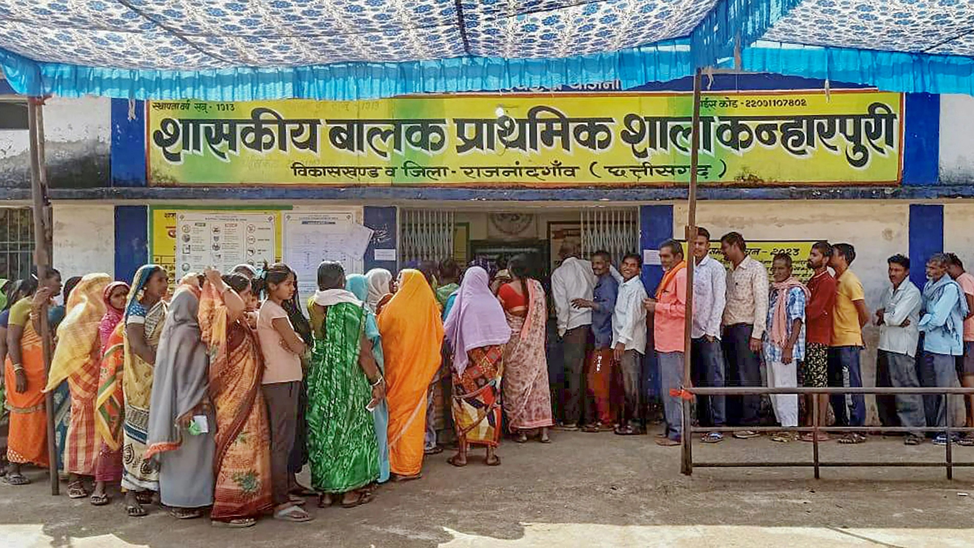 <div class="paragraphs"><p>Voters wait in a queue to cast their votes for the 1st phase of Chhattisgarh Assembly elections, at a polling station.</p></div>