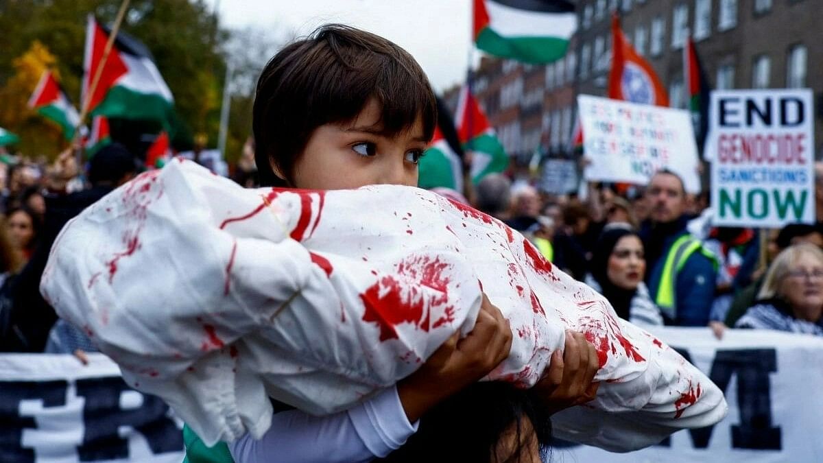 <div class="paragraphs"><p>A child holds a fake body wrapped in cloth during a protest in solidarity with Palestinians in Gaza, amid the ongoing conflict between Israel and the Palestinian Islamist group Hamas, in Dublin, Ireland, November 18, 2023. </p></div>