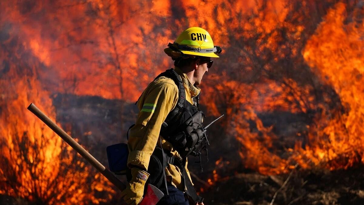 <div class="paragraphs"><p>A firefighter works to extinguish the Highland Fire, a wind driven wildfire near Aguanga, California, US., October 31, 2023.</p></div>