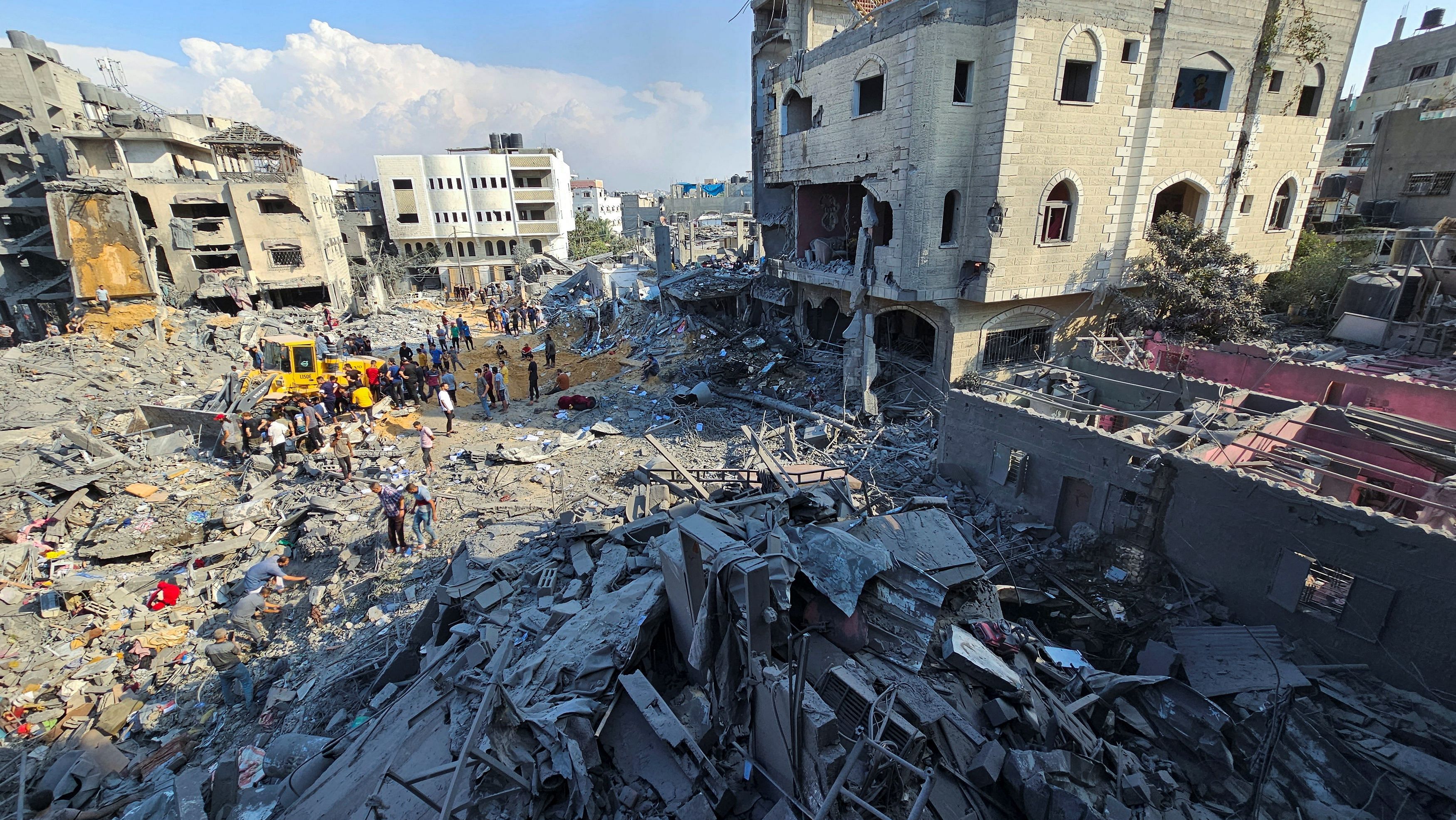 <div class="paragraphs"><p>Palestinians gather at the site of Israeli strikes on houses in Jabalia refugee camp in the northern Gaza Strip, November 1, 2023. </p></div>