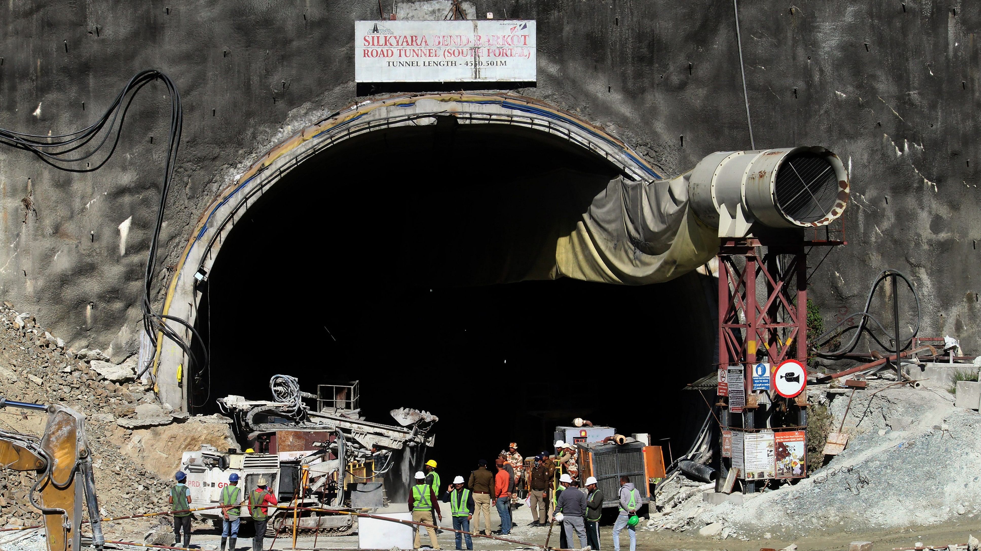 <div class="paragraphs"><p>Security personnel and others at the under-construction tunnel between Silkyara and Dandalgaon on the Brahmakhal-Yamunotri national highway, days after a portion of the tunnel collapsed trapping several workers inside, in Uttarkashi district, Saturday, Nov. 18, 2023. </p></div>