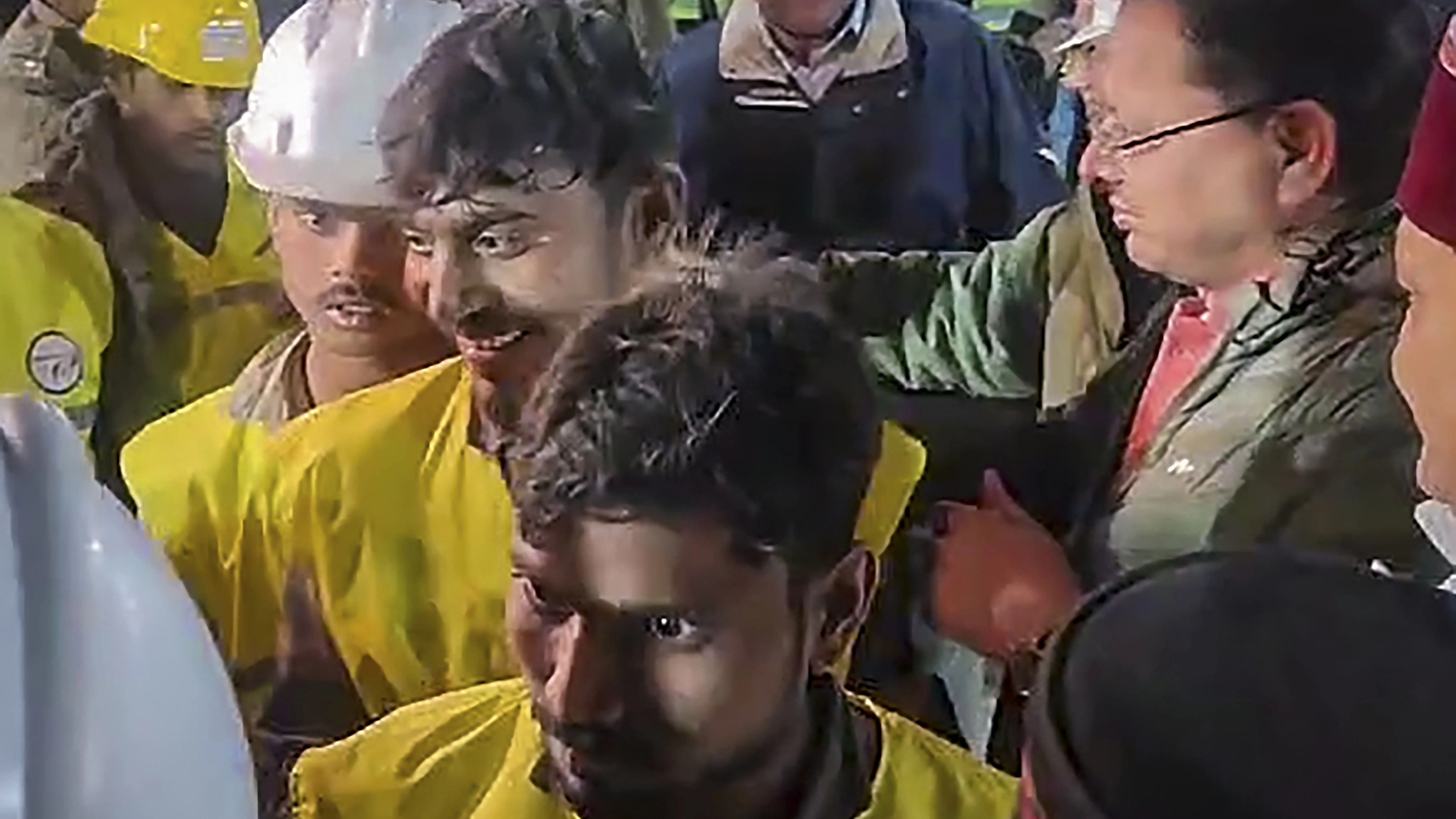 <div class="paragraphs"><p>Uttarakhand Chief Minister Pushkar Singh Dhami and Union Minister of State for Road Transport &amp; Highways VK Singh greet rescued workers coming out of the collapsed Silkyara Tunnel, in Uttarkashi district, Tuesday, Nov. 28, 2023  </p></div>
