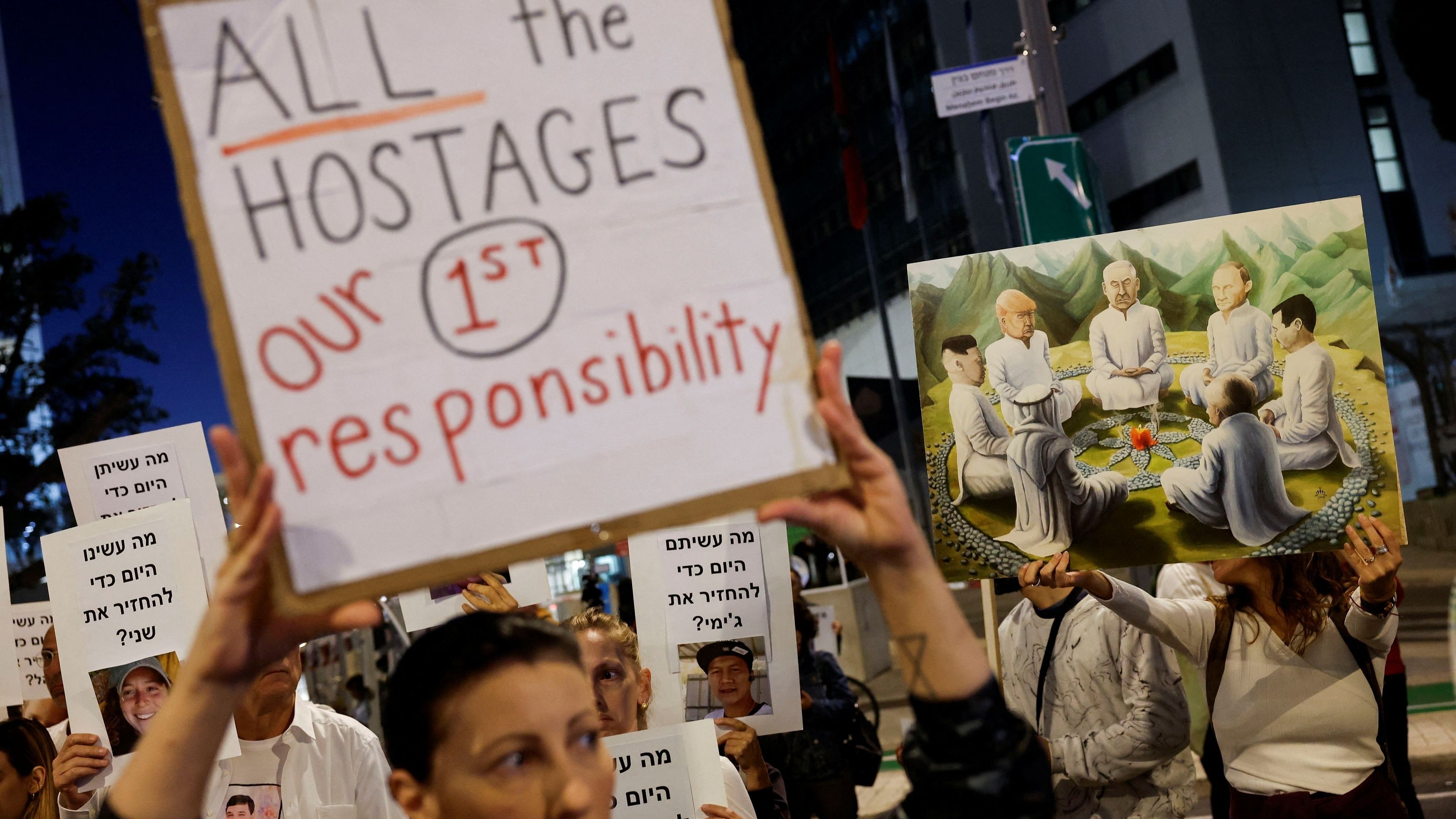 <div class="paragraphs"><p>Protesters hold signs demanding the liberation of hostages who are being held in the Gaza Strip after they were seized by Hamas gunmen on October 7, in Tel Aviv, Israel November 21, 2023. </p></div>