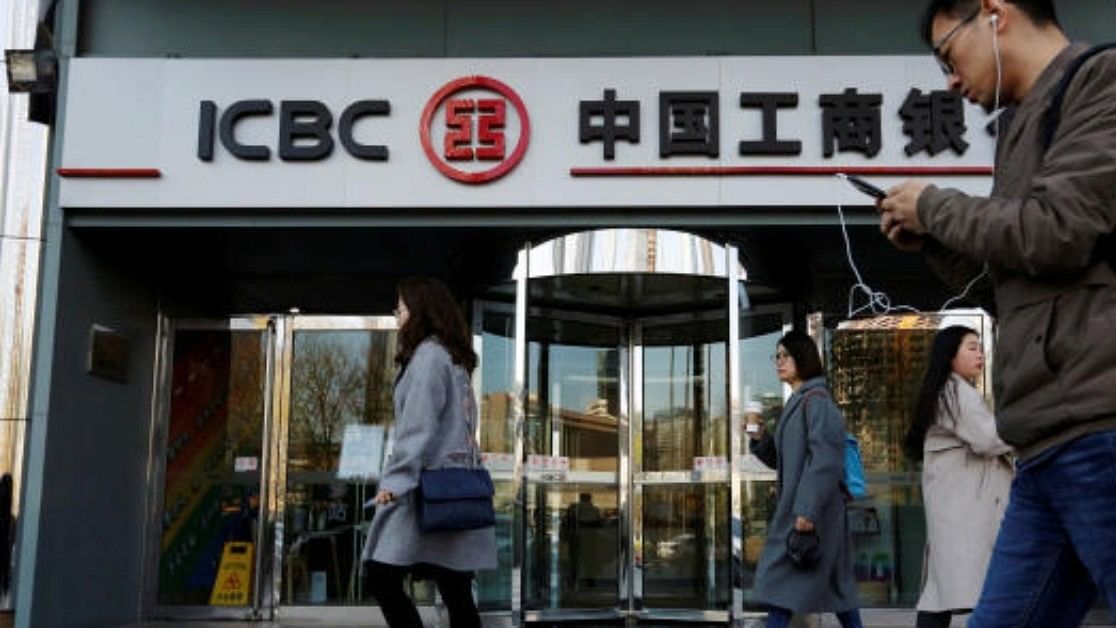 <div class="paragraphs"><p>People walk past a branch of Industrial and Commercial Bank of China (ICBC) in Beijing, China. </p></div>