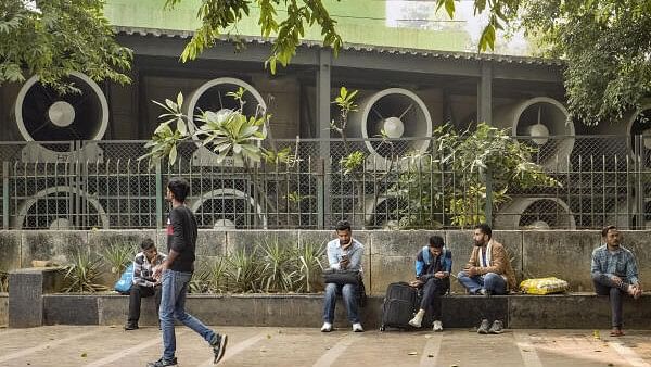 <div class="paragraphs"><p>People outside a Smog Tower at Connaught Place.</p></div>