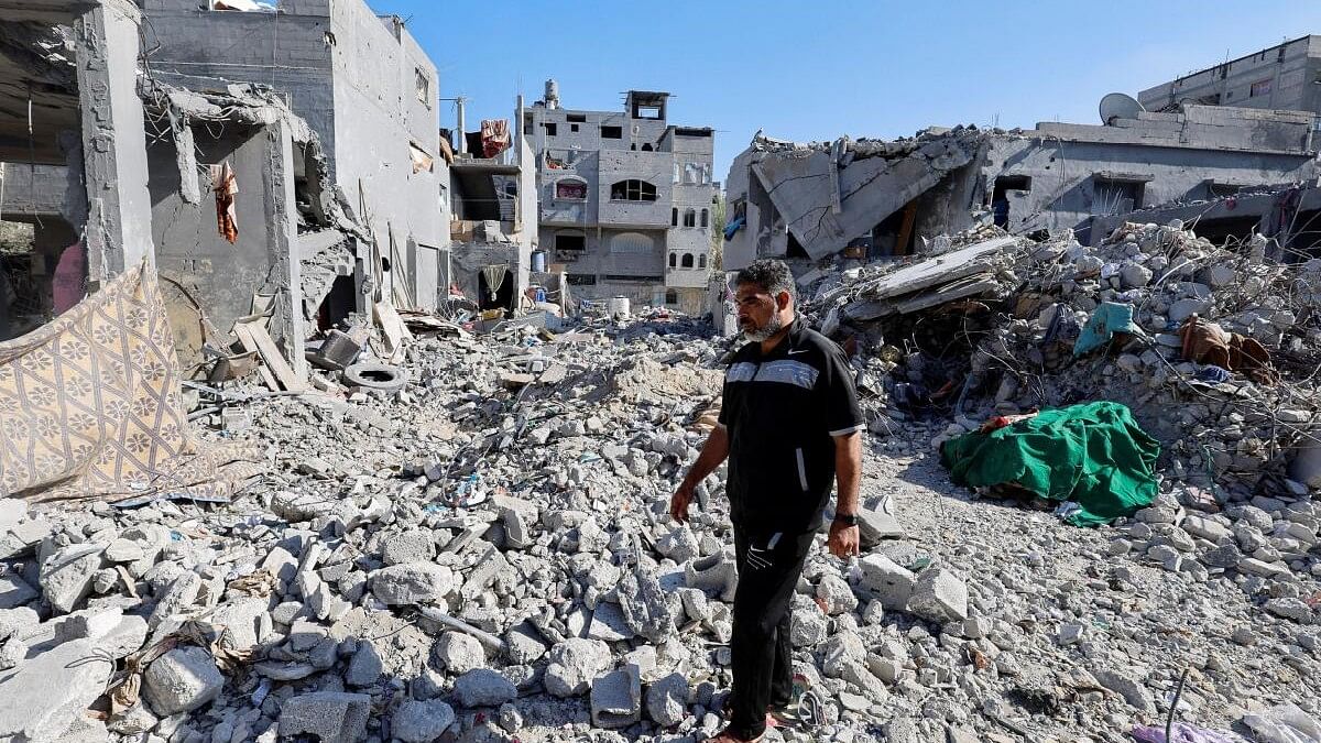 <div class="paragraphs"><p>Mohammed Hamdan, who lost 35 family members of three generations in an Israeli air strike, walks amid the rubble of his family home that was destroyed in the strike in&nbsp;southern Gaza Strip.&nbsp;</p></div>