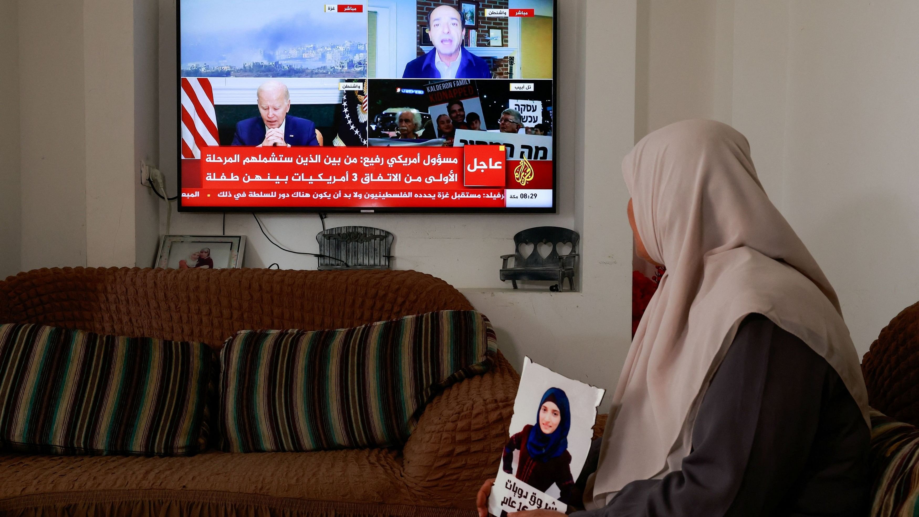<div class="paragraphs"><p>Sameera Dwayyat, the mother of Shorouq Dwayyat, 26, a female Palestinian prisoner serving a 16-year sentence, watches television news updates on the hostages and Palestinian prisoner exchange deal, amid the ongoing conflict between Israel and the Palestinian Islamist group Hamas, in Jerusalem.</p></div>