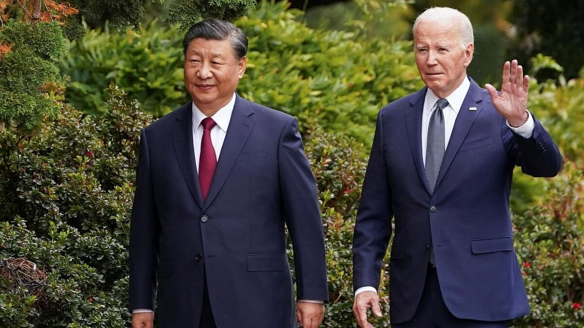 <div class="paragraphs"><p>Joe Biden waves as he walks with Chinese President Xi Jinping at Filoli estate on the sidelines of the Asia-Pacific Economic Cooperation (APEC) summit, in Woodside, California.</p></div>