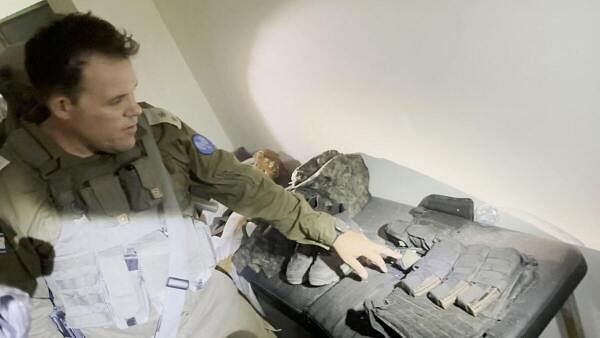 <div class="paragraphs"><p>An Israeli officer points at equipment that he says was discovered in a bag at the Al Shifa hospital complex.</p></div>