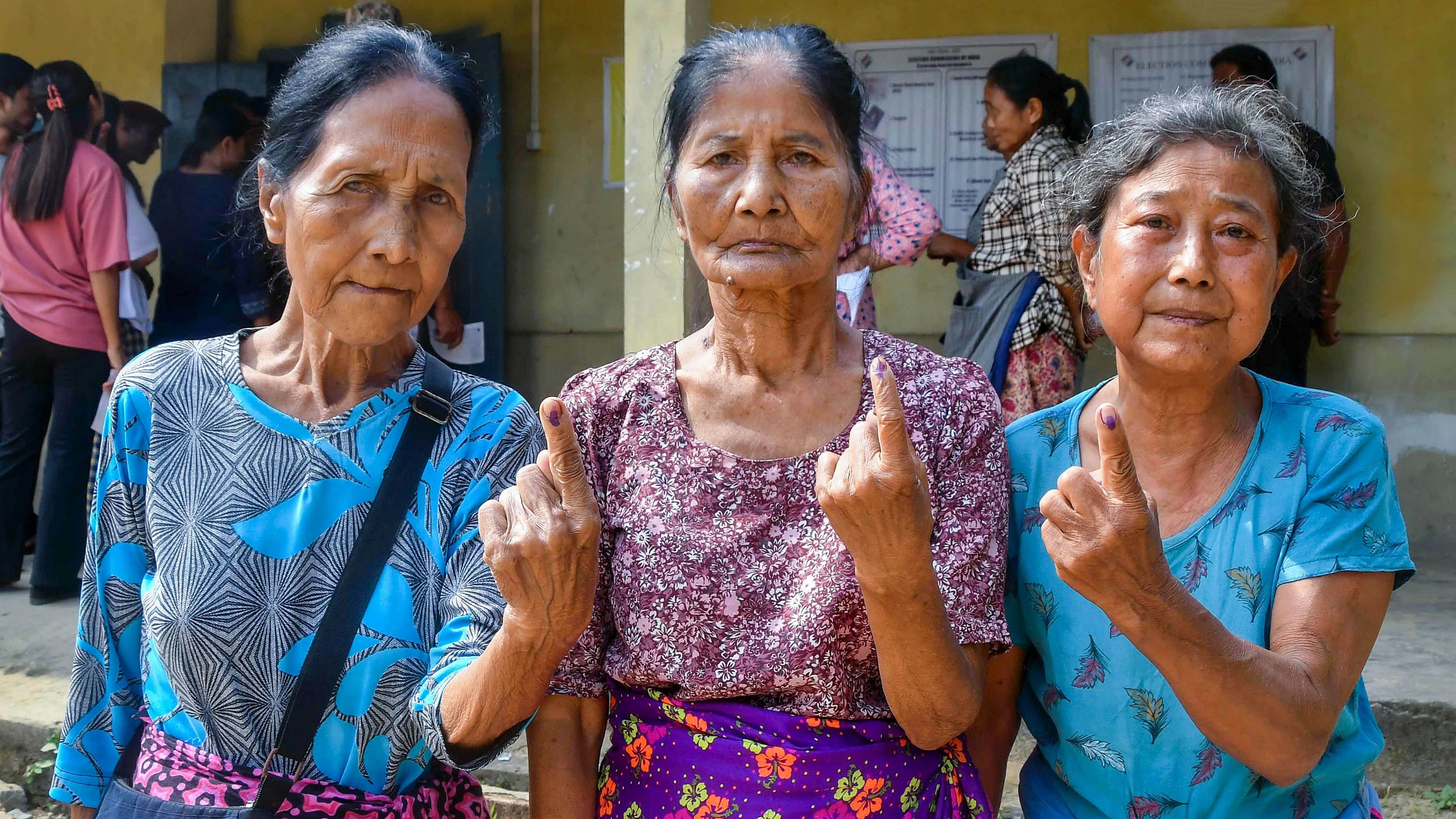 <div class="paragraphs"><p>Voters show their fingers marked with indelible ink after casting their votes for Mizoram Assembly elections.</p></div>