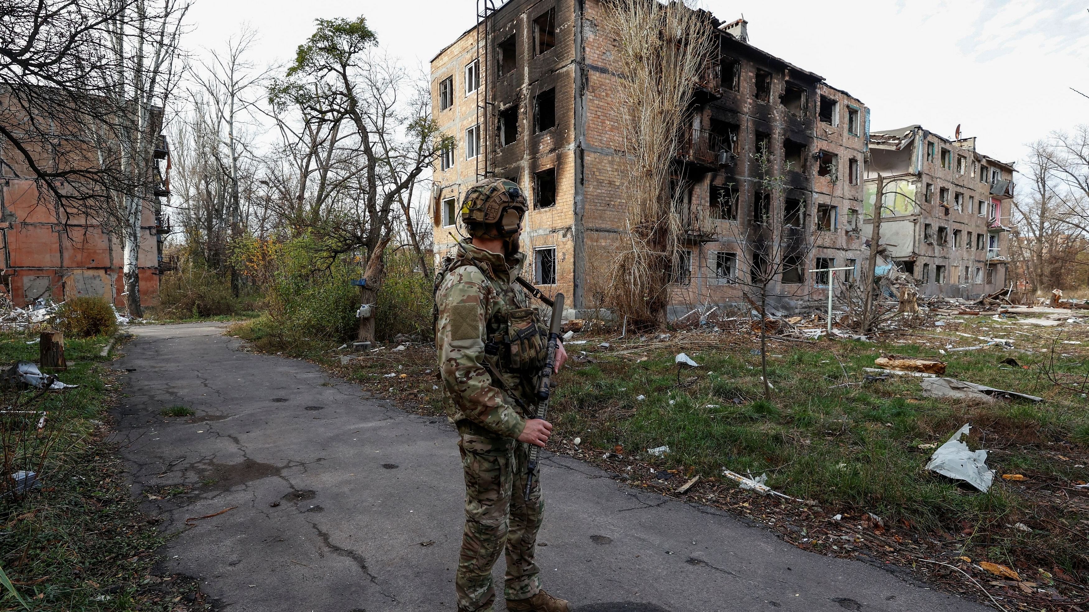 <div class="paragraphs"><p>A Ukrainian serviceman stands next to residential buildings heavily damaged by permanent Russian military strikes in the front line town of Avdiivka, amid Russia's attack on Ukraine, in Donetsk region, Ukraine November 8, 2023. </p></div>