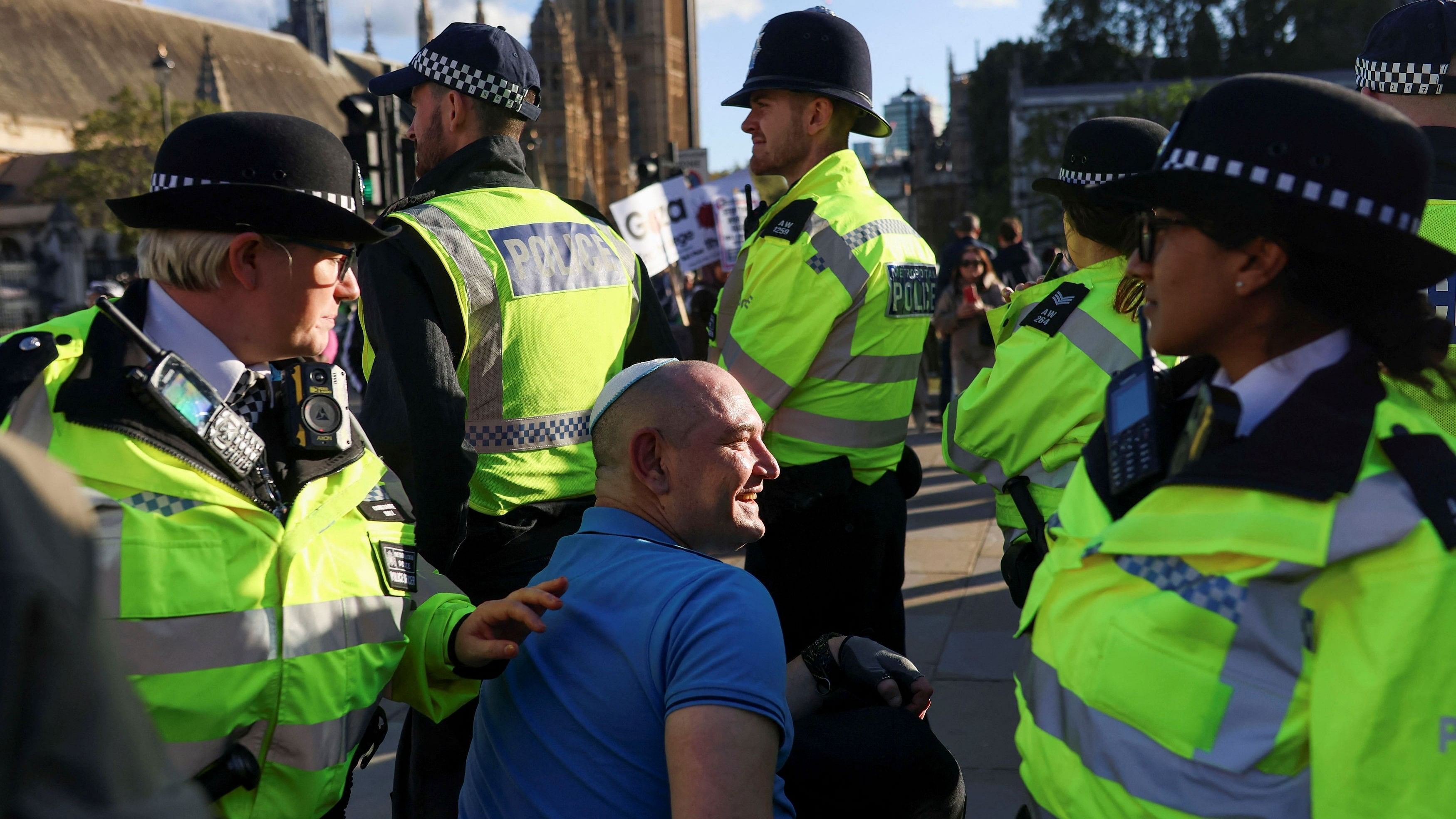 A Jewish man reacts, surrounded by police members, as demonstrators protest in solidarity with Palestinians, amid the ongoing conflict between Israel and the Palestinian Islamist group Hamas, in London, Britain, October 14, 2023. REUTERS/Susannah Ireland