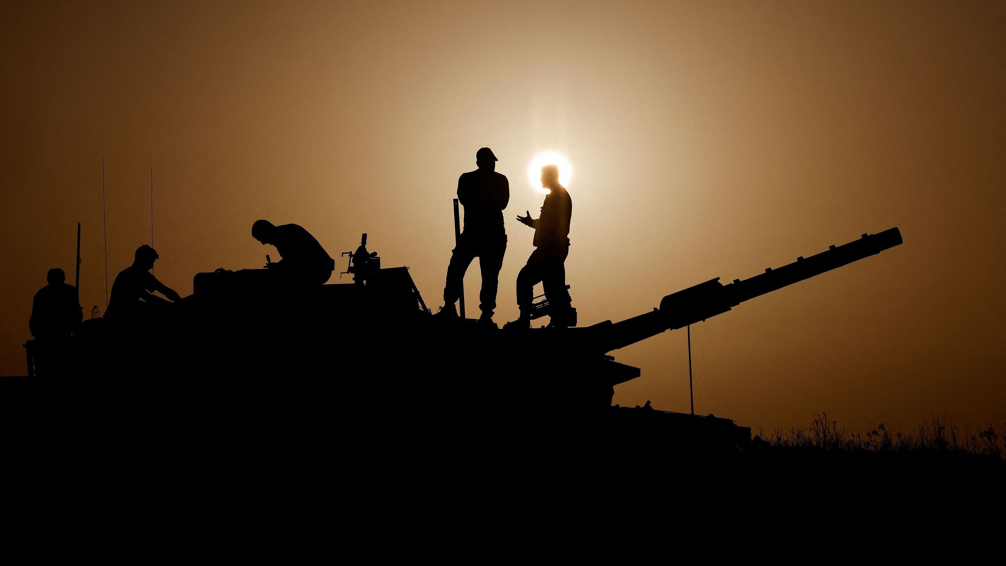 <div class="paragraphs"><p>Israeli soldiers stand on a tank, amid the ongoing conflict between Israel and the Palestinian group Hamas, near Israel's border with Gaza in southern Israel, November 23, 2023. </p></div>