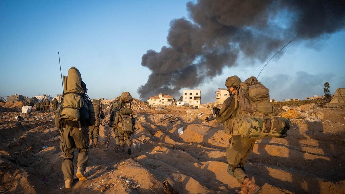 <div class="paragraphs"><p>Israeli soldiers take position, amid the ongoing ground operation of the Israeli army against Palestinian Islamist group Hamas, in the Gaza Strip.</p></div>