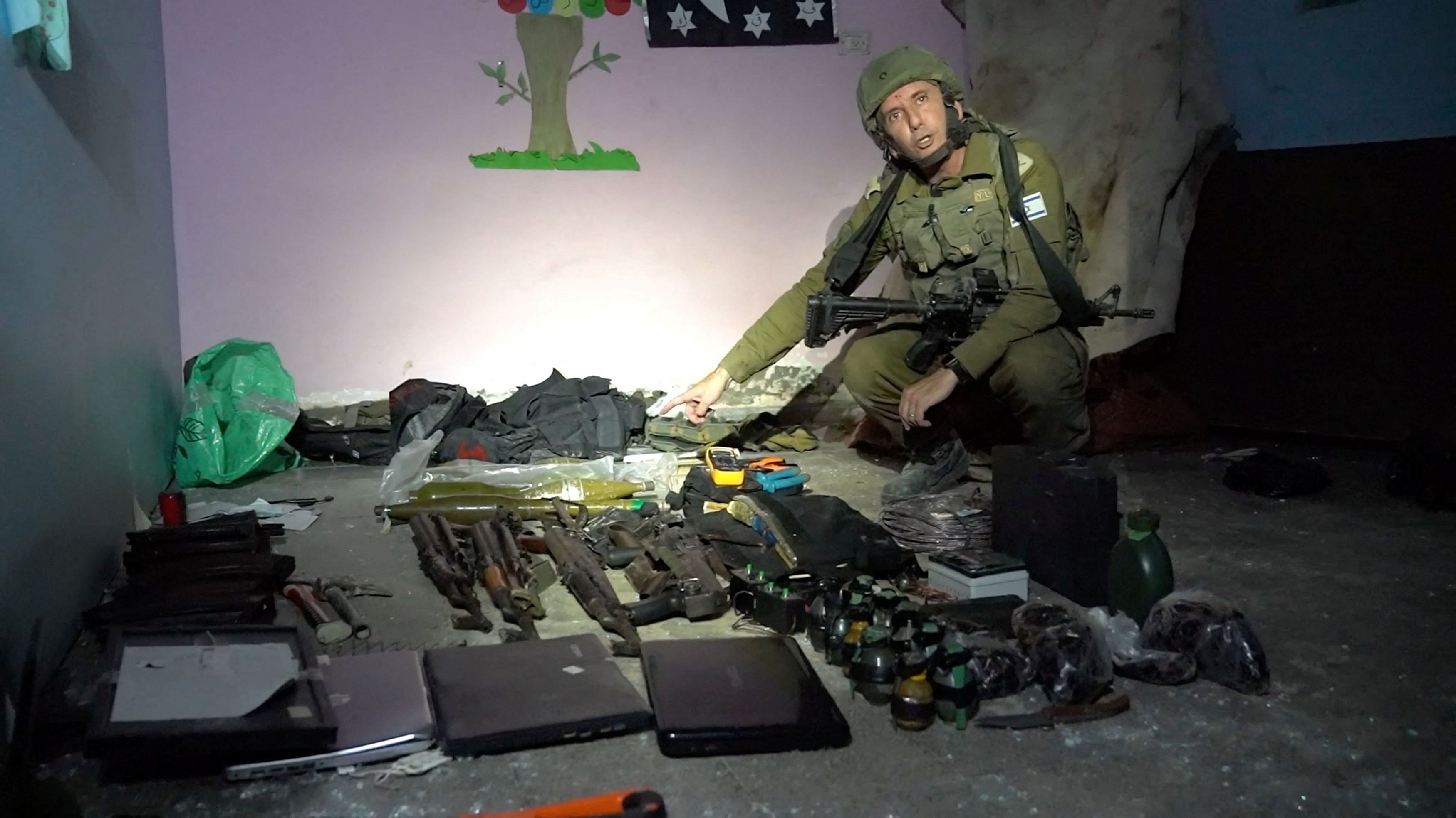 <div class="paragraphs"><p>Israeli military spokesperson Rear Admiral Daniel Hagari shows what he says are weapons stored by Hamas in the basement of Rantissi Hospital, a paediatric hospital with a specialty in treating cancer patients, at a location given as Gaza, in this still image taken from video released November 13, 2023.</p></div>