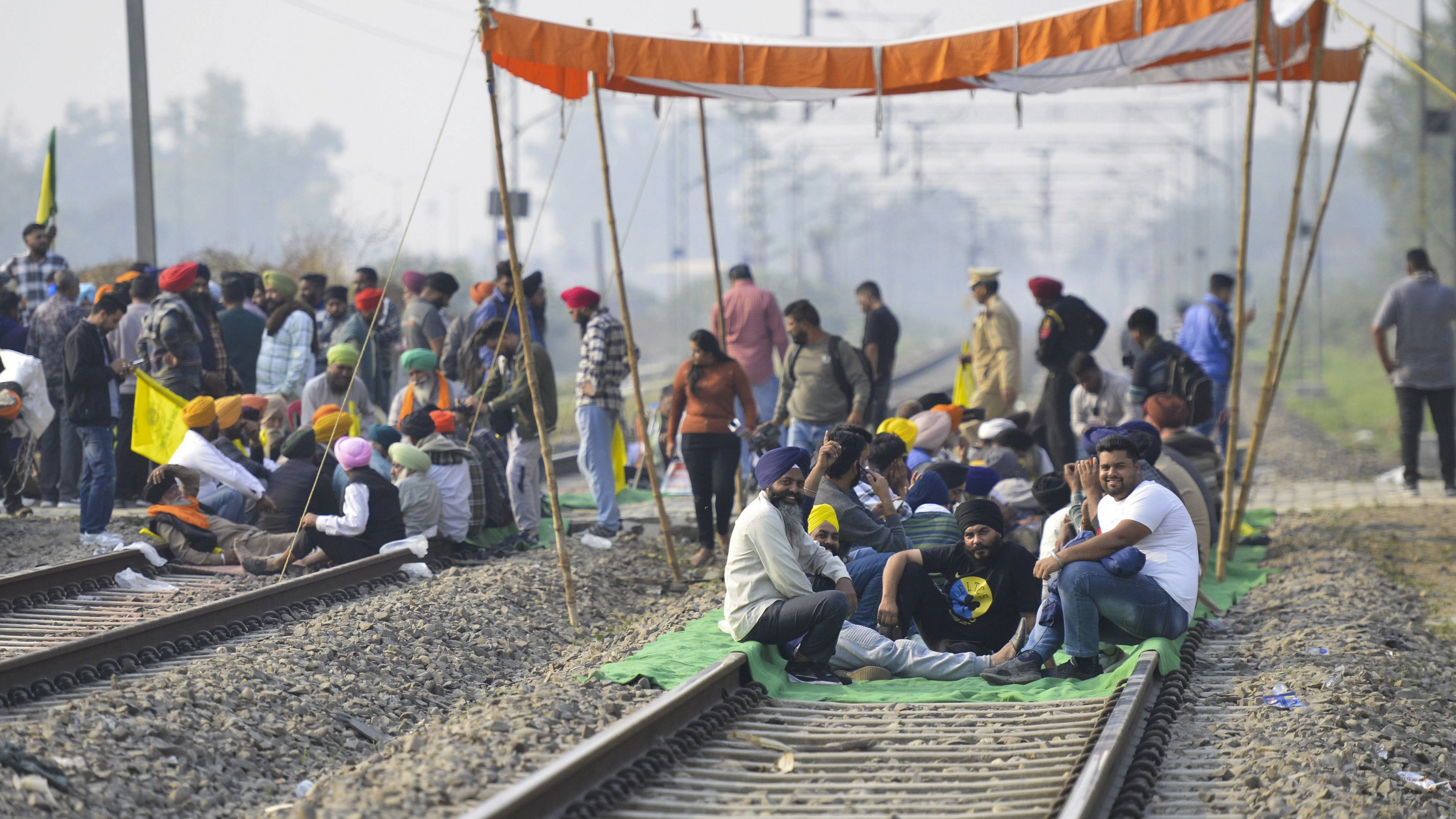 <div class="paragraphs"><p>Farmers sit on a railway track during an indefinite protest demanding an increase in sugarcane prices among other demands, in Jalandhar.</p></div>