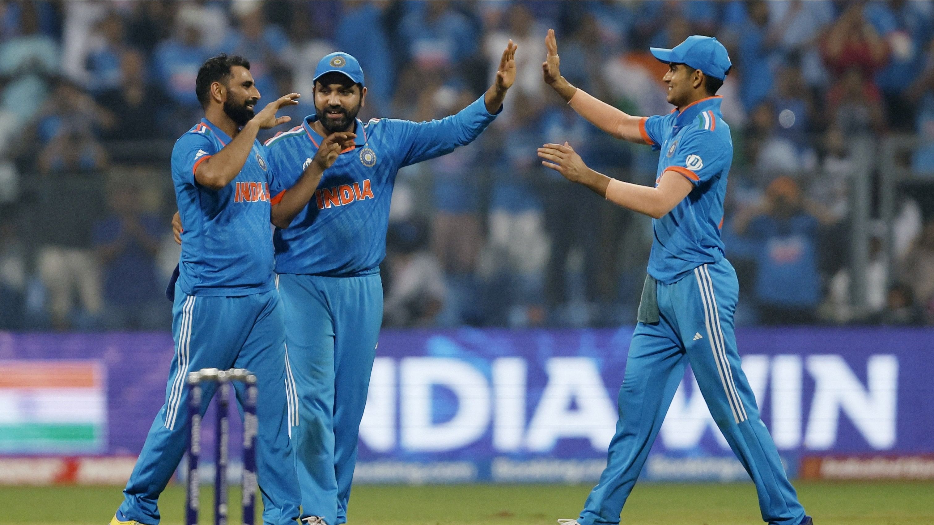 <div class="paragraphs"><p>Mohammed Shami celebrates with Rohit Sharma and Shubman Gill after taking the wicket of New Zealand's Lockie Ferguson, caught out by KL Rahul to win the match and advance to the finals.</p></div>