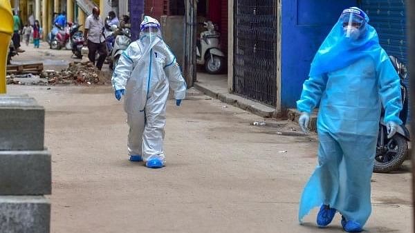 <div class="paragraphs"><p>Medics wearing PPE kits arrive to conduct Covid-19 Rapid Antigen tests. </p></div>