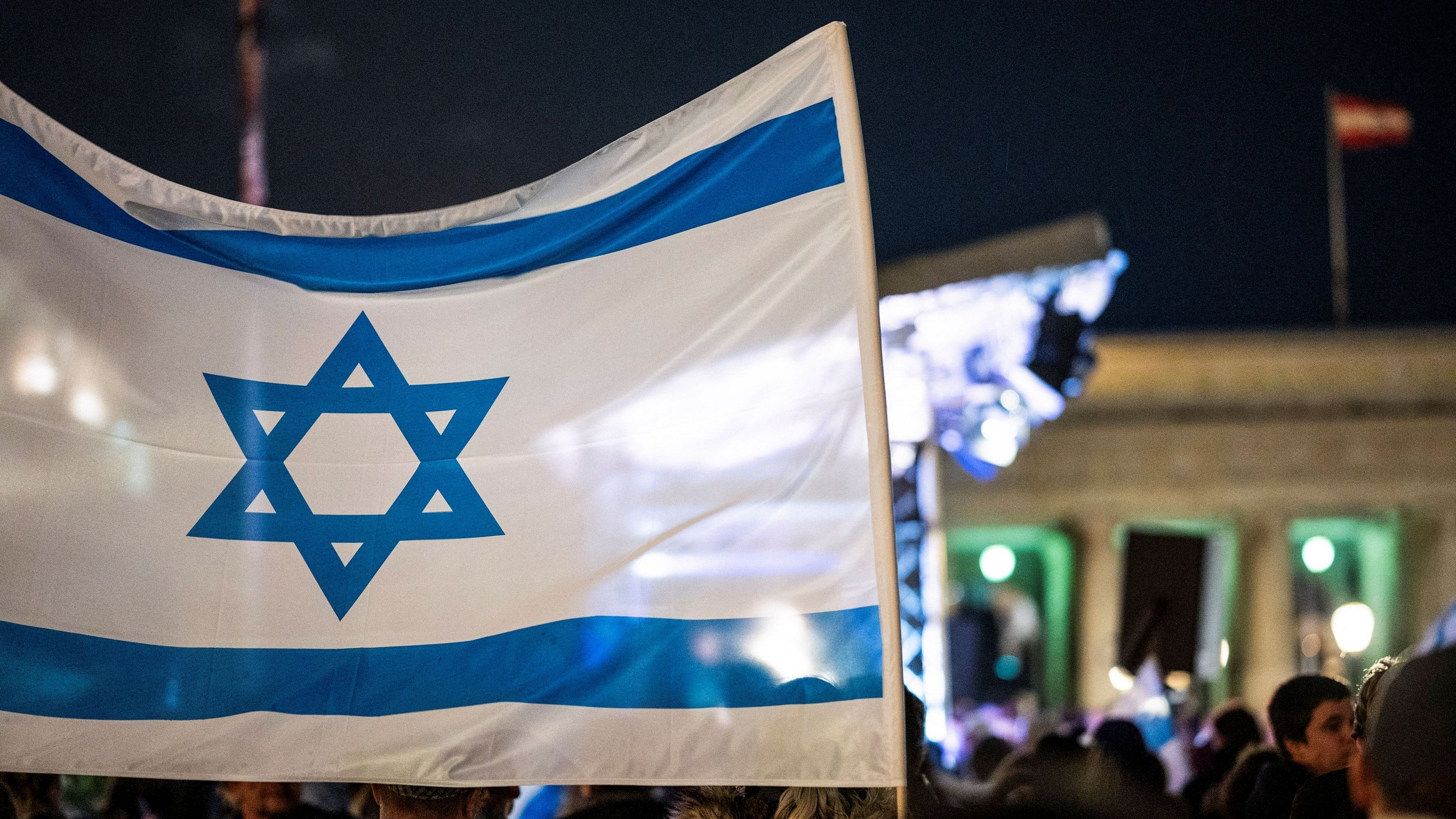 <div class="paragraphs"><p>An Israeli flag flutters during a solidarity demonstration for Israeli hostages taken by Hamas and missing people waiting to come home.</p></div>