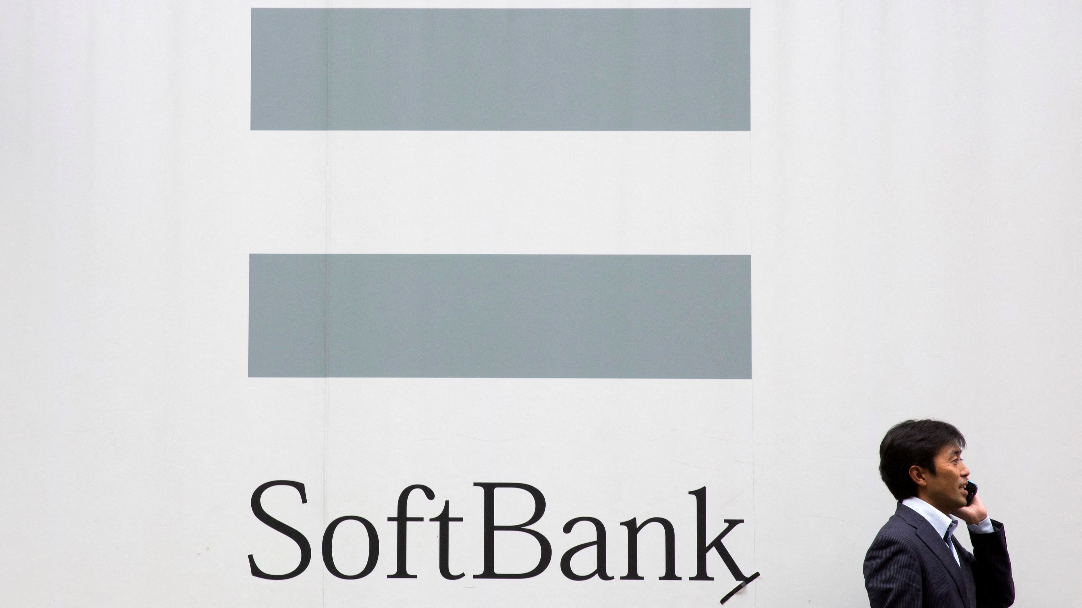 <div class="paragraphs"><p>A man walks past the SoftBank logo.</p></div>