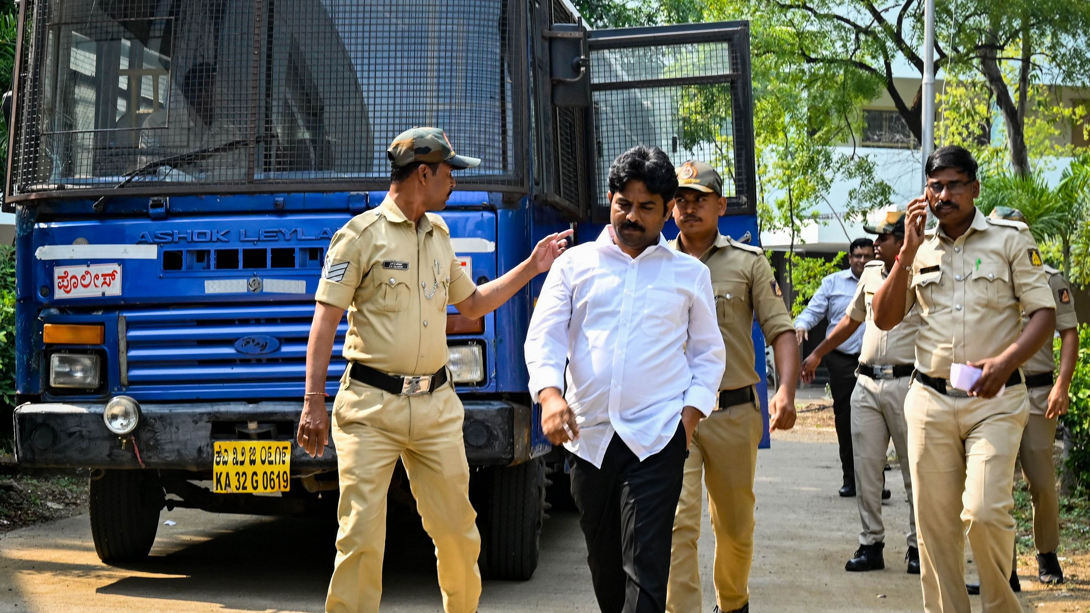 CID officials take KEA exam malpractice kingpin R D Patil to produce him before the court in Kalaburagi on Wednesday.