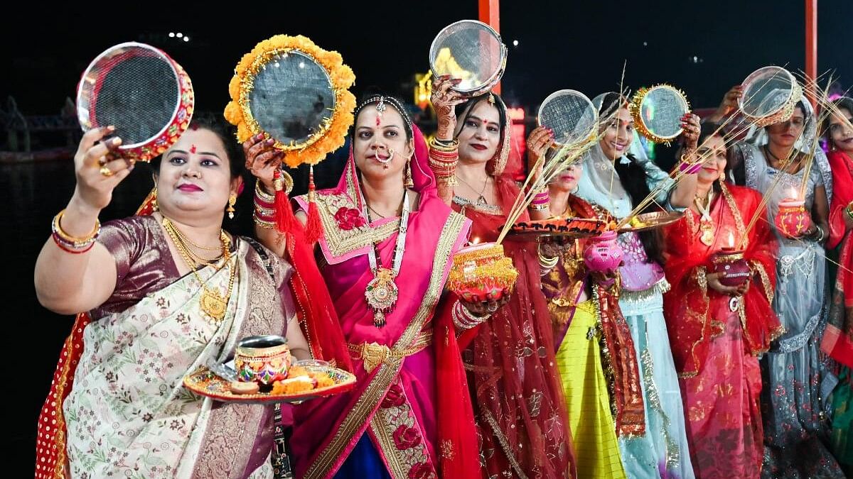 <div class="paragraphs"><p>Married women look at the moon through a sieve as part of rituals on the occasion of "Karwa Chauth" festival in Jabalpur.</p></div>