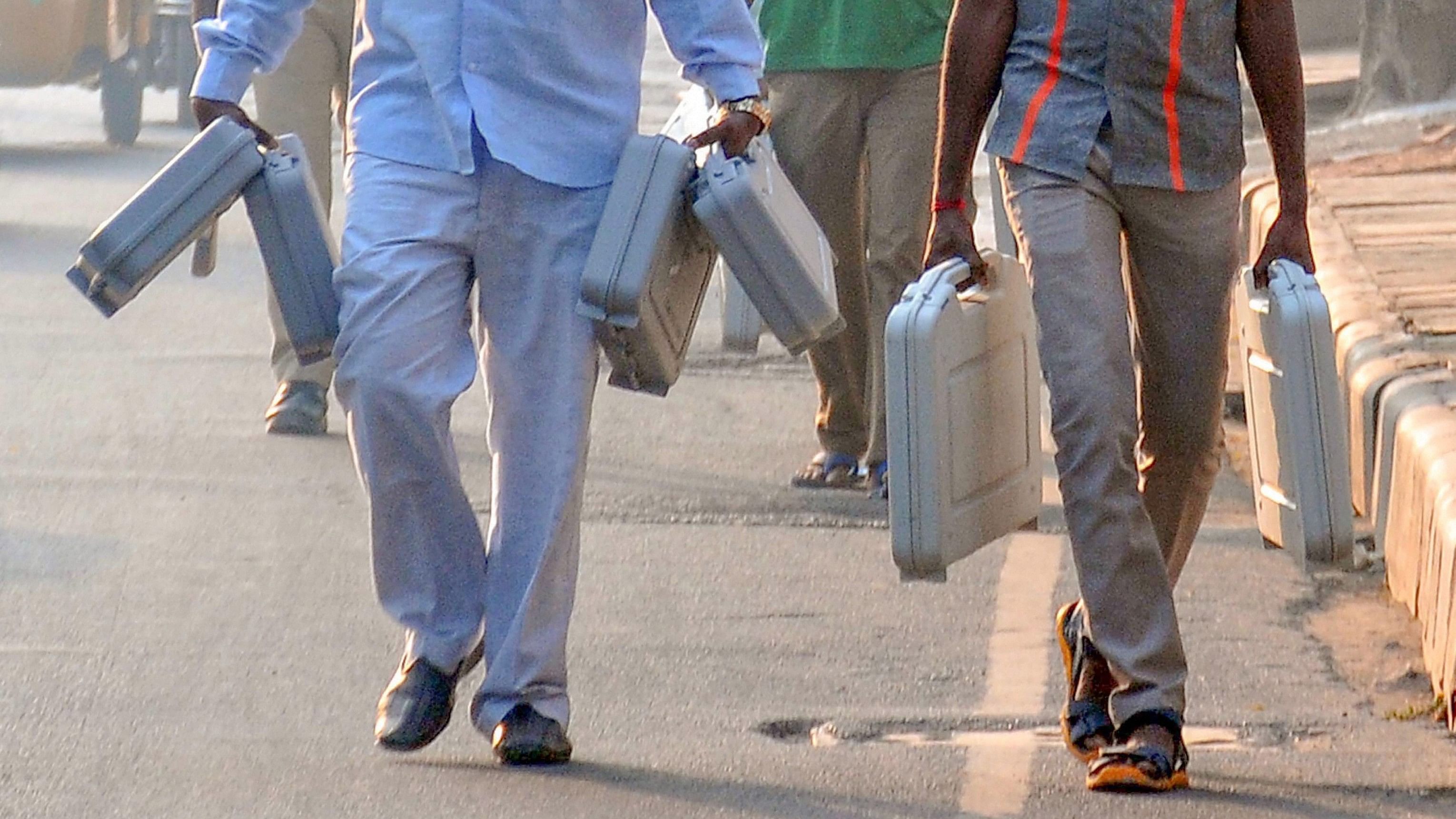 <div class="paragraphs"><p>Polling officials carry EVMs to a polling station at Victory Playground in Hyderabad.&nbsp;</p></div>