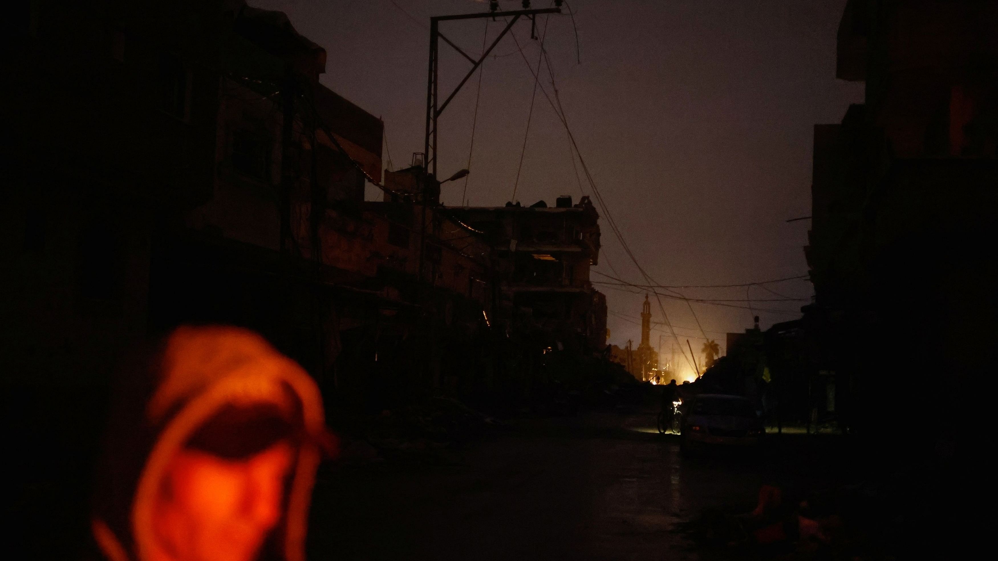 <div class="paragraphs"><p>A Palestinian stands next to the rubble of a house hit in an Israeli strike during the conflict, amid a temporary truce between Hamas and Israel, in Khan Younis in the southern Gaza Strip November 27, 2023. </p></div>