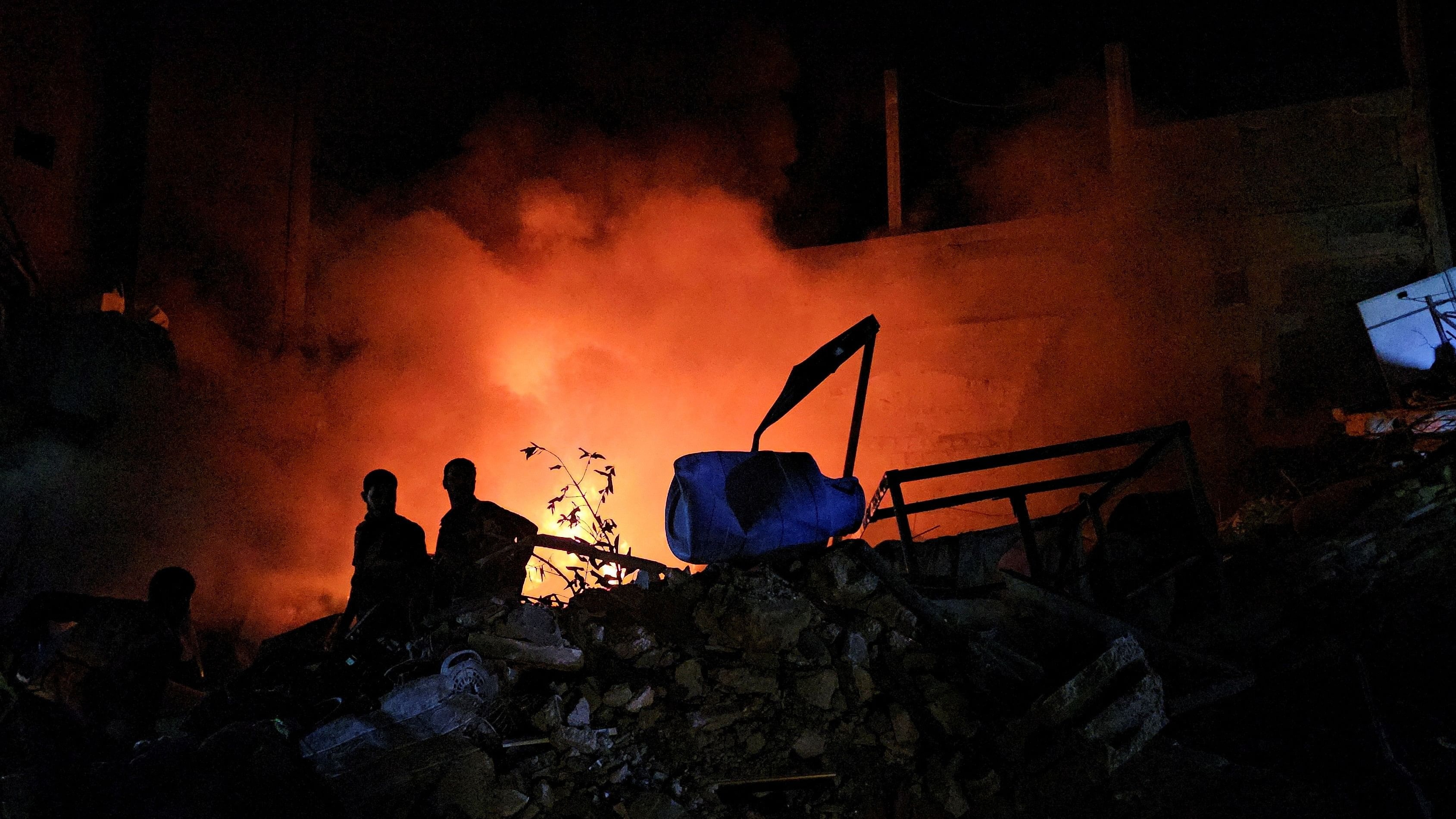 <div class="paragraphs"><p>Palestinians gather at the site of an Israeli strike on a house in Jabalia refugee camp on the northern Gaza Strip on November 4, 2023. </p></div>