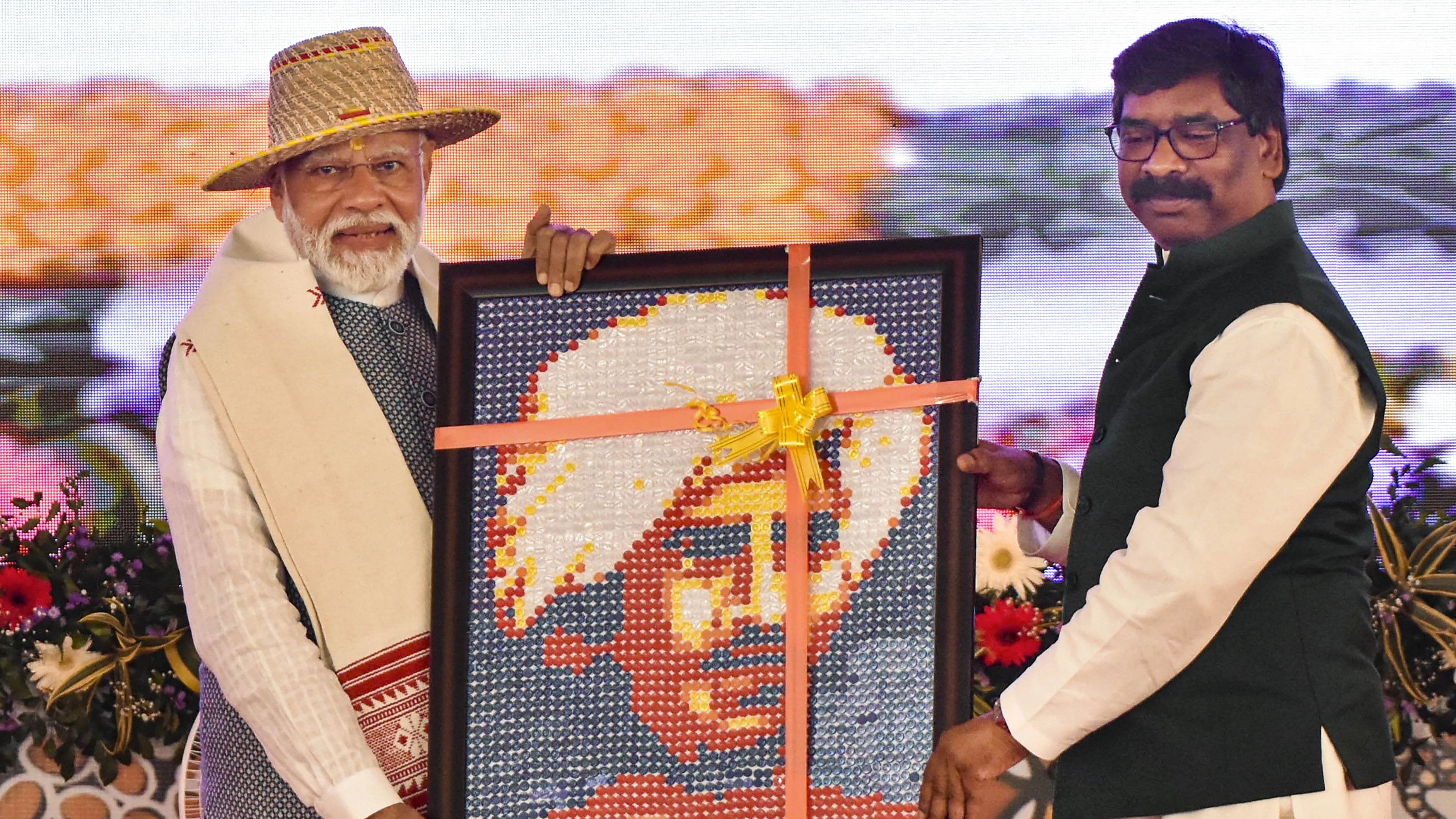 <div class="paragraphs"><p>Prime Minister Narendra Modi receives a portrait of tribal icon Birsa Munda from Jharkhand Chief Minister Hemant Soren during the Jan Jatiya Guarv Diwas and Jharkhand Foundation Day celebrations in Khunti, Jharkhand, Wednesday, Nov. 15, 2023.   </p></div>