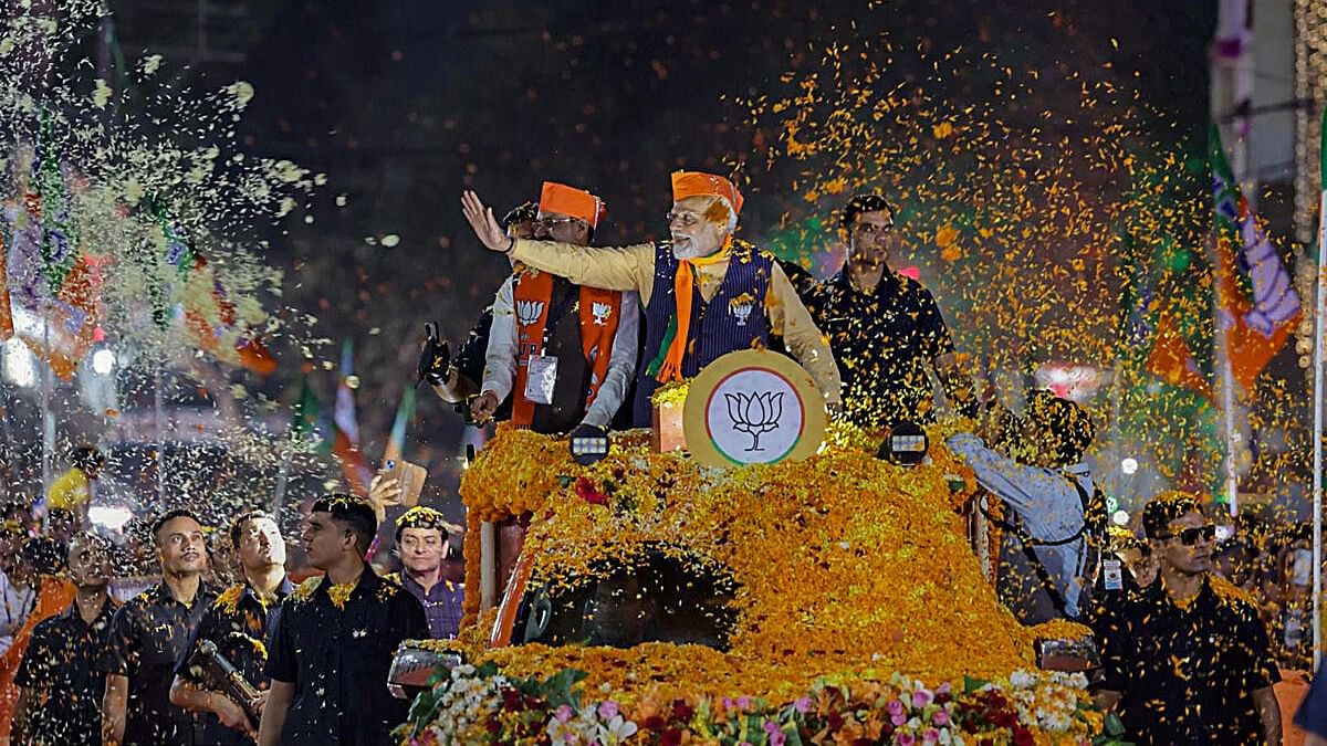 <div class="paragraphs"><p>Prime Minister Narendra Modi waves at supporters during a roadshow ahead of the Madhya Pradesh Assembly elections, in Indore, Tuesday, Nov. 14, 2023.</p></div>