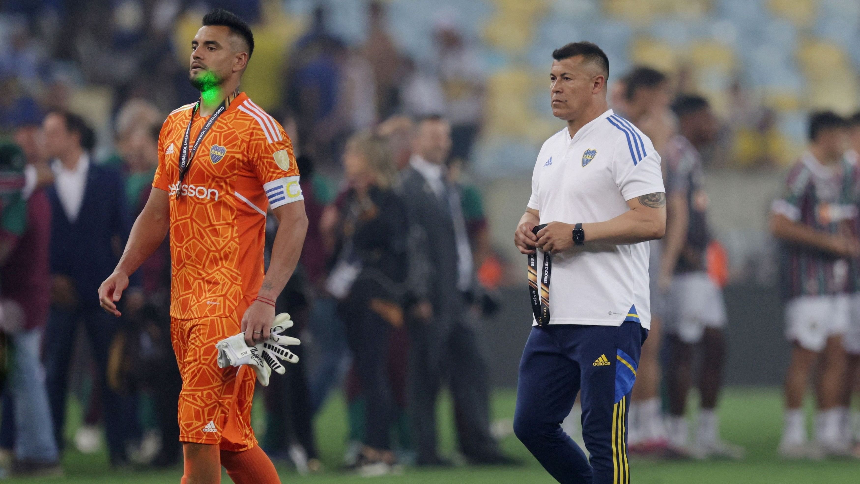 <div class="paragraphs"><p>Boca Juniors' Sergio Romero and coach Jorge Almiron look dejected after the match.</p></div>