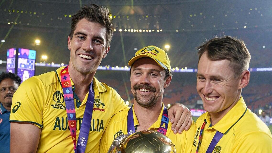 <div class="paragraphs"><p>Australian captain Pat Cummins, Travis Head and Marnus Labuschagne pose for photographs with the trophy as they celebrate after winning the ICC Men’s Cricket World Cup 2023 finals at the Narendra Modi Stadium, in Ahmedabad.</p></div>