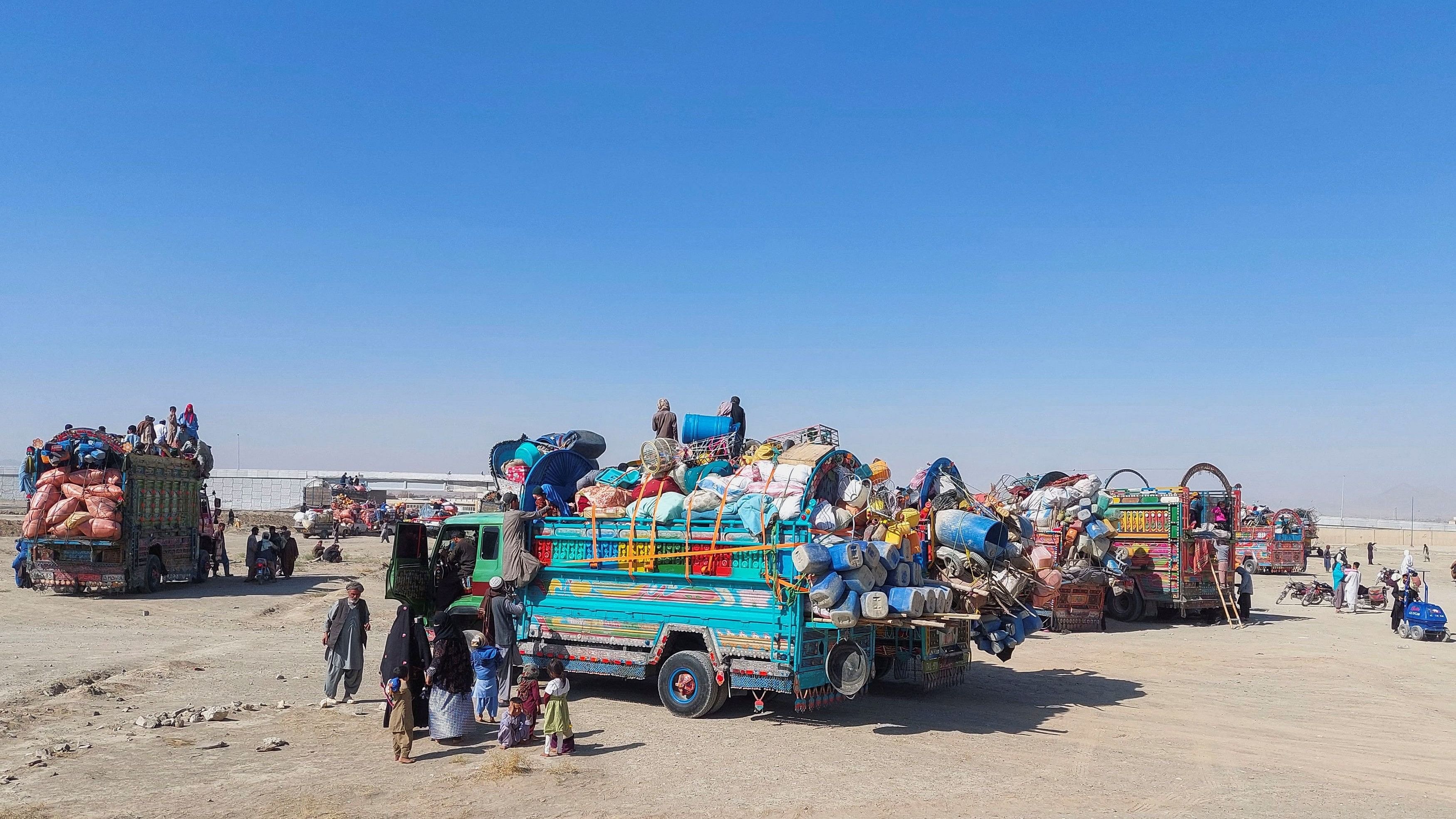 <div class="paragraphs"><p>An Afghan family stands by their truck, loaded with belongings as they along with others are returning home, after Pakistan gives the last warning to undocumented immigrants to leave.</p></div>