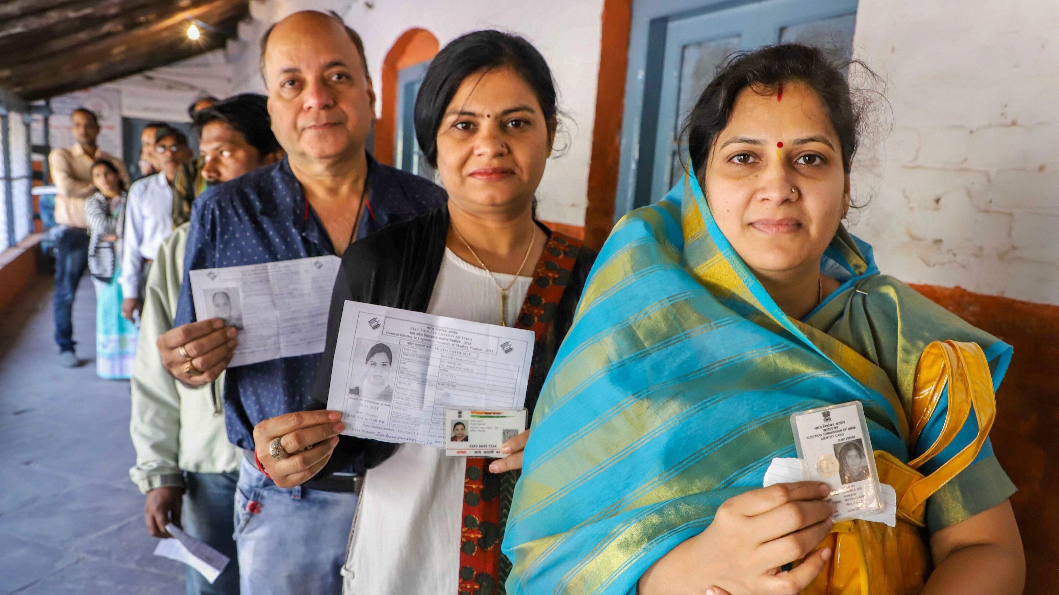 <div class="paragraphs"><p>People wait with their identity cards to cast their votes for the Assembly elections, in Jabalpur, Madhya Pradesh.&nbsp;</p></div>