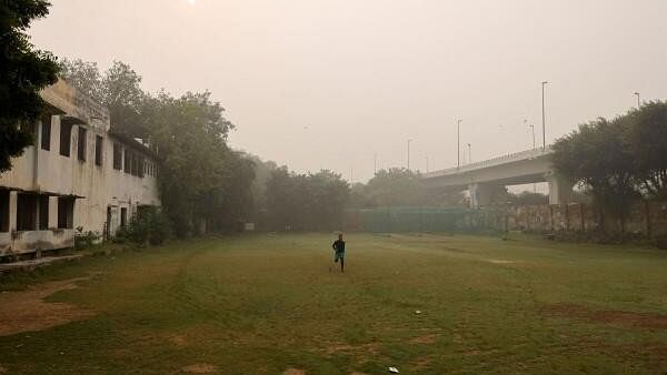 <div class="paragraphs"><p>A man exercises on a playground of the school after primary classes were ordered shut by the Delhi government for Friday and Saturday as the air pollution increased and the air quality index (AQI) plummeted, on a smoggy morning in New Delhi, India, November 3, 2023.</p></div>