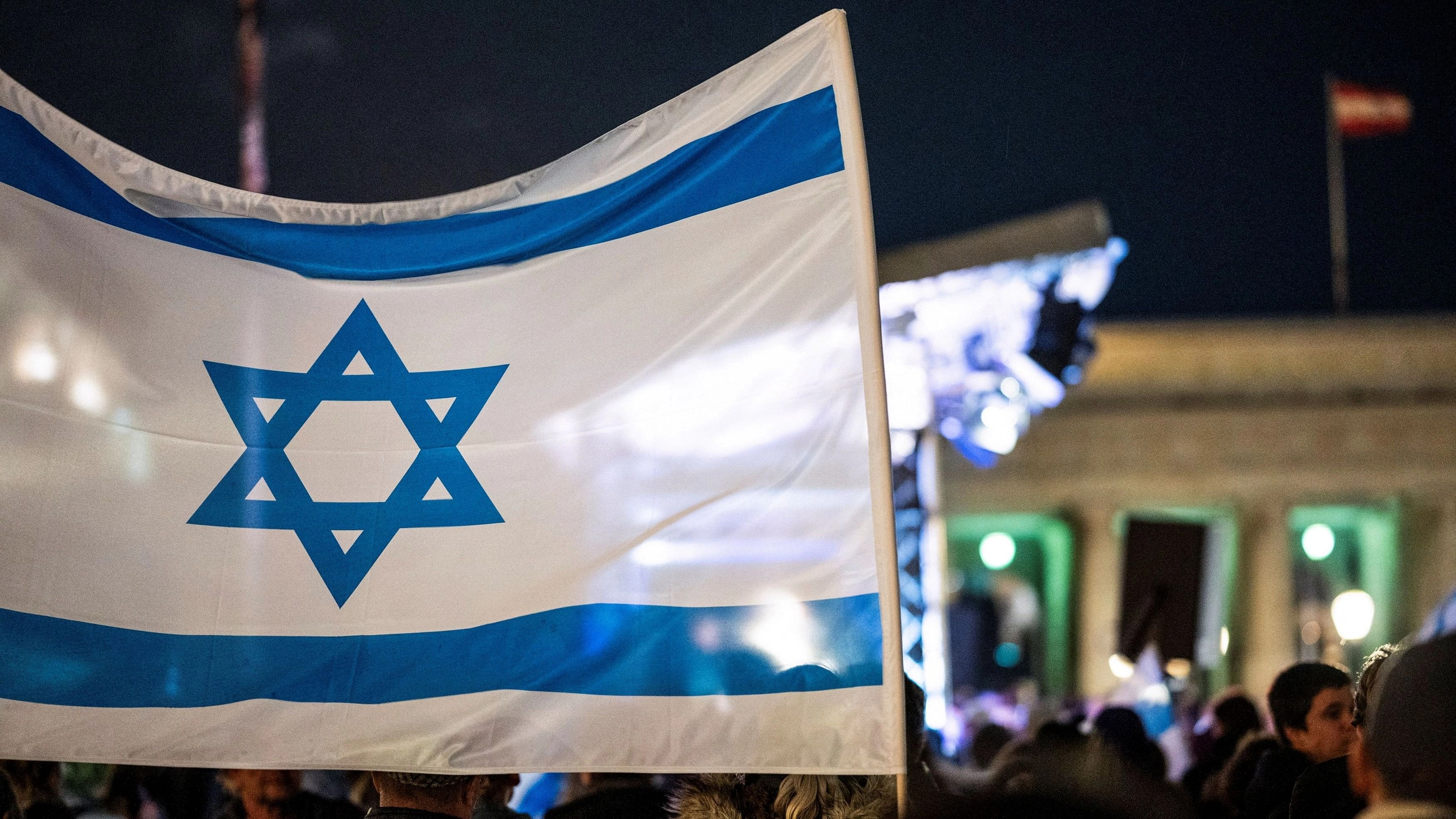 <div class="paragraphs"><p>An Israeli flag flutters during a solidarity demonstration for Israeli hostages taken by Hamas and missing people waiting to come home, following a deadly infiltration of Israel by Hamas gunmen from the Gaza Strip.</p></div>