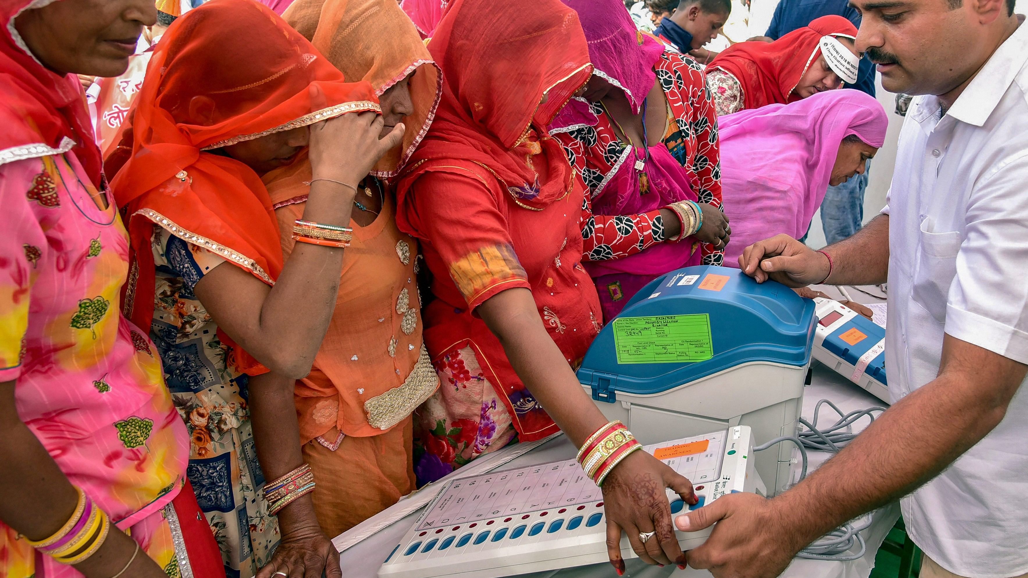 <div class="paragraphs"><p>Electoral officials demonstrate the functioning of an Electronic Voting Machine (EVM) and Voter-Verified Paper Audit Trail (VVPAT) to the locals during a voter awareness programme ahead of Rajasthan State Assembly elections.&nbsp;</p></div>