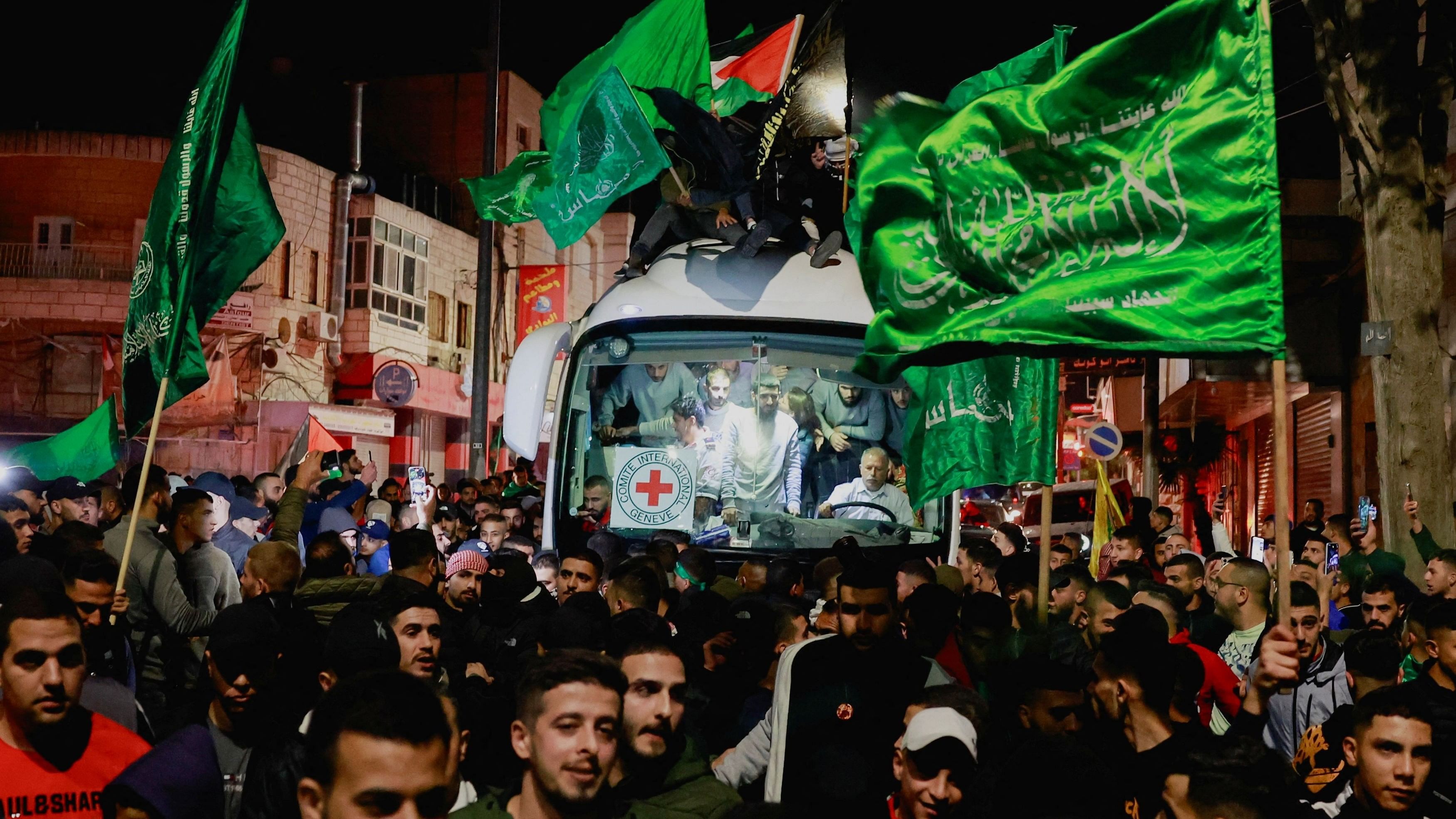 <div class="paragraphs"><p>Released Palestinian prisoners react from inside a vehicle after leaving the Israeli military prison, Ofer, amid a hostages-prisoners swap deal between Hamas and Israel, near Ramallah in the Israeli-occupied West Bank November 26, 2023. </p></div>