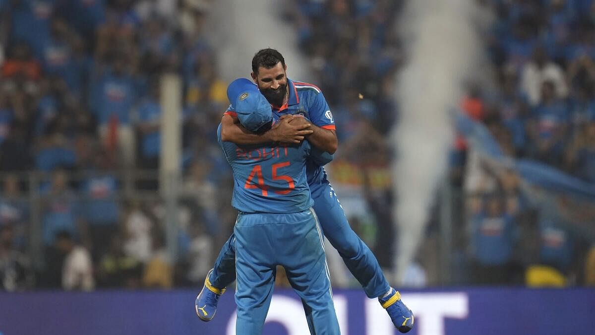 <div class="paragraphs"><p>Mohammed Shami celebrates with captain Rohit Sharma after winning the ICC Men's Cricket World Cup 2023 first semi-final match against New Zealand</p></div>