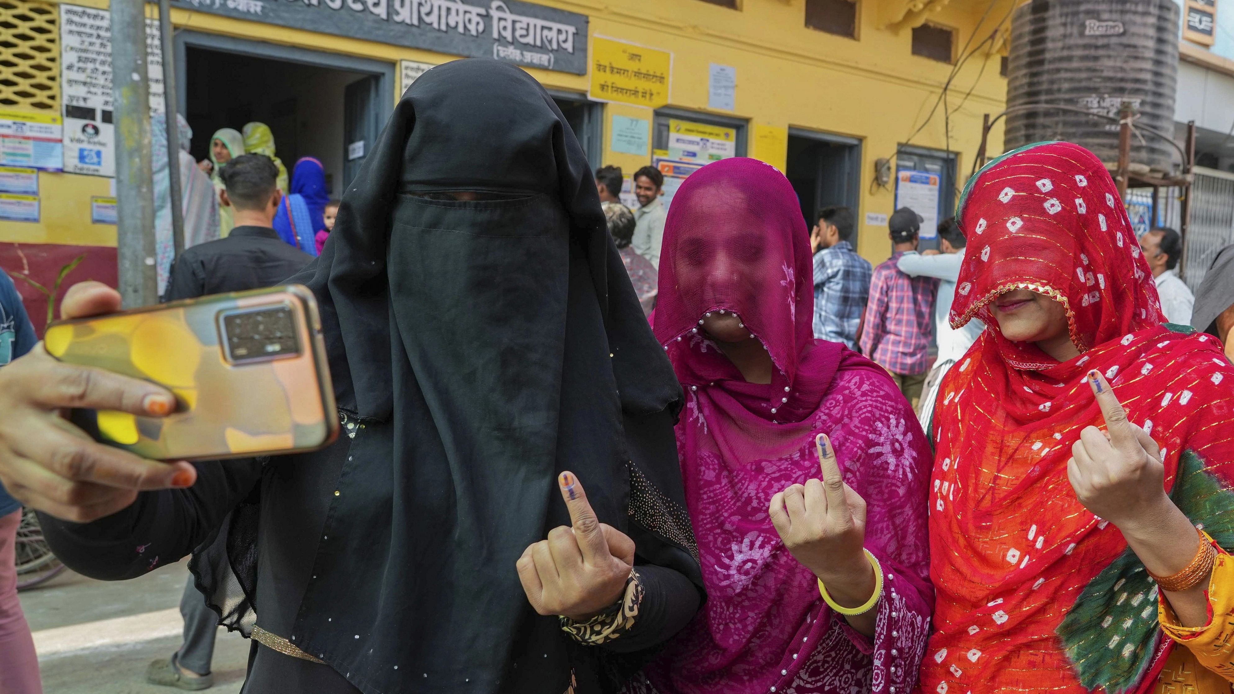 <div class="paragraphs"><p>Beawar: Women pose for a selfie showing their fingers marked with indelible ink after casting their votes during Rajasthan Assembly elections, in Beawar district, Saturday, Nov. 25, 2023. </p></div>