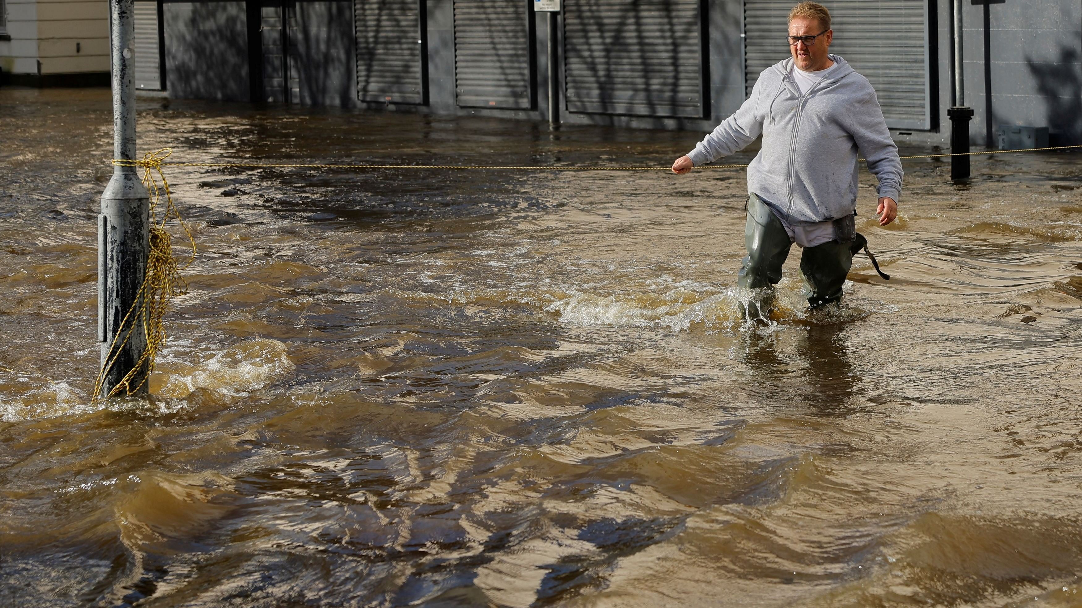 <div class="paragraphs"><p>A man walks through a strong current as water flows through the streets after heavy rain caused extensive flooding, ahead of the arrival of Storm Ciaran, in the city centre of Newry, Northern Ireland, October 31, 2023. </p></div>