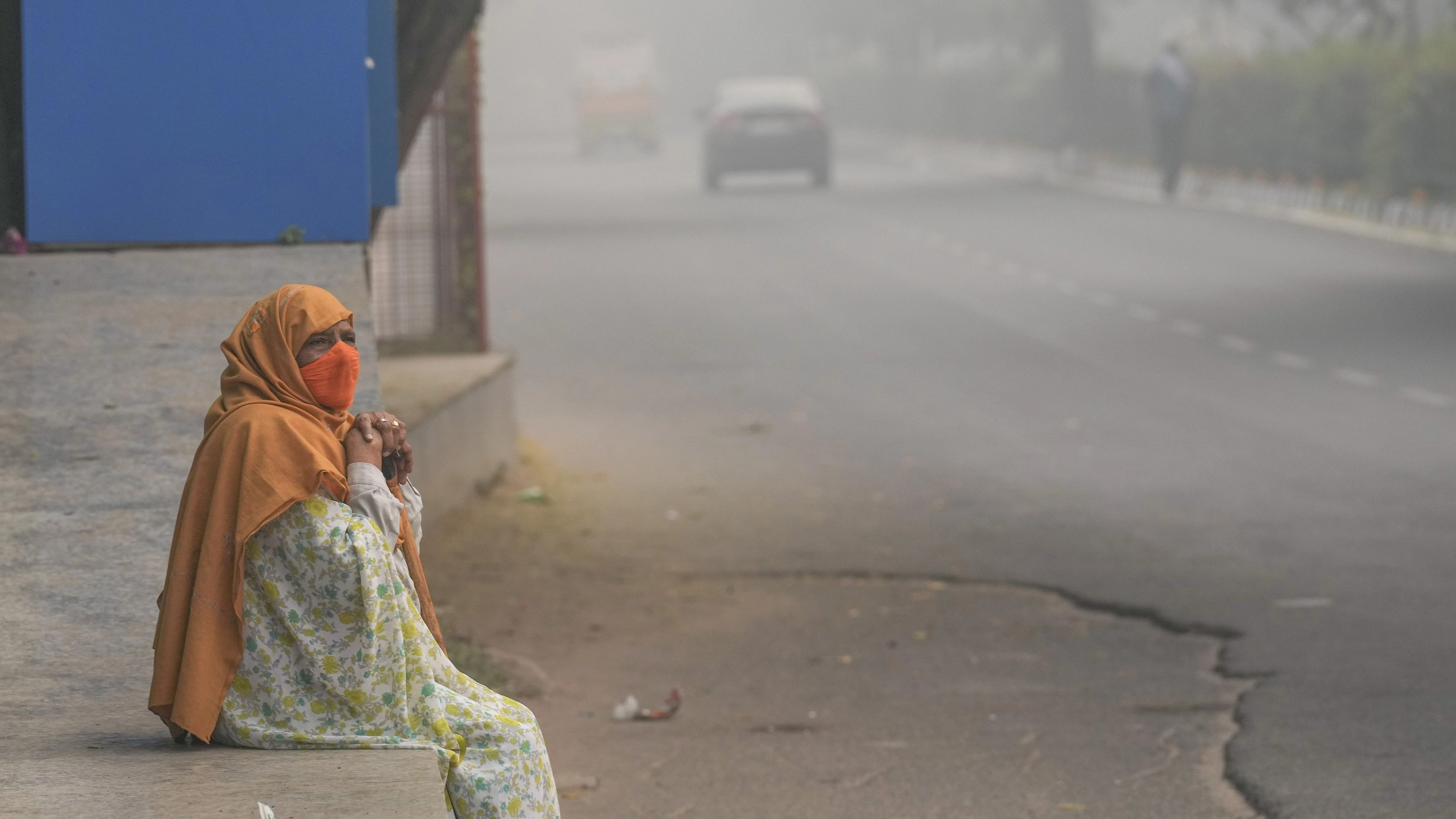 <div class="paragraphs"><p>New Delhi: An elderly woman sits on a pavement during a smoggy morning, in New Delhi, Thursday, Nov. 9, 2023. </p></div>