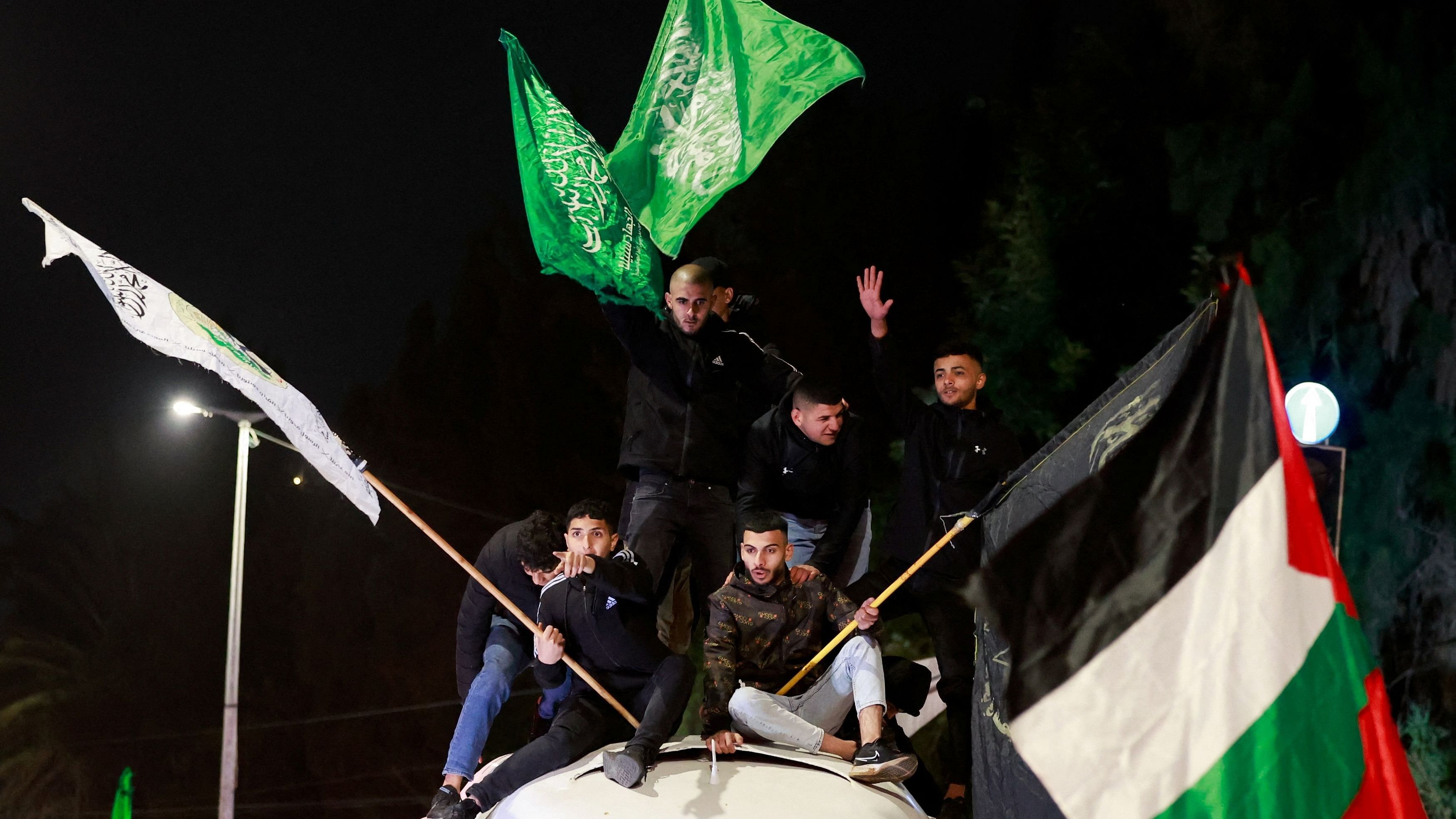 <div class="paragraphs"><p>People wave flags as released Palestinian prisoners leave an Israeli military prison.</p></div>