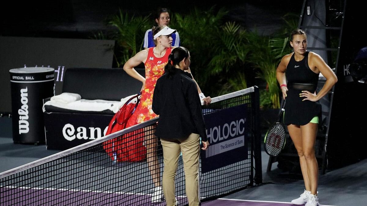 <div class="paragraphs"><p>The umpire talks to the players after the rain starts again during the match between Belarus' Aryna Sabalenka and Kazakhstan's Elena Rybakina.</p></div>