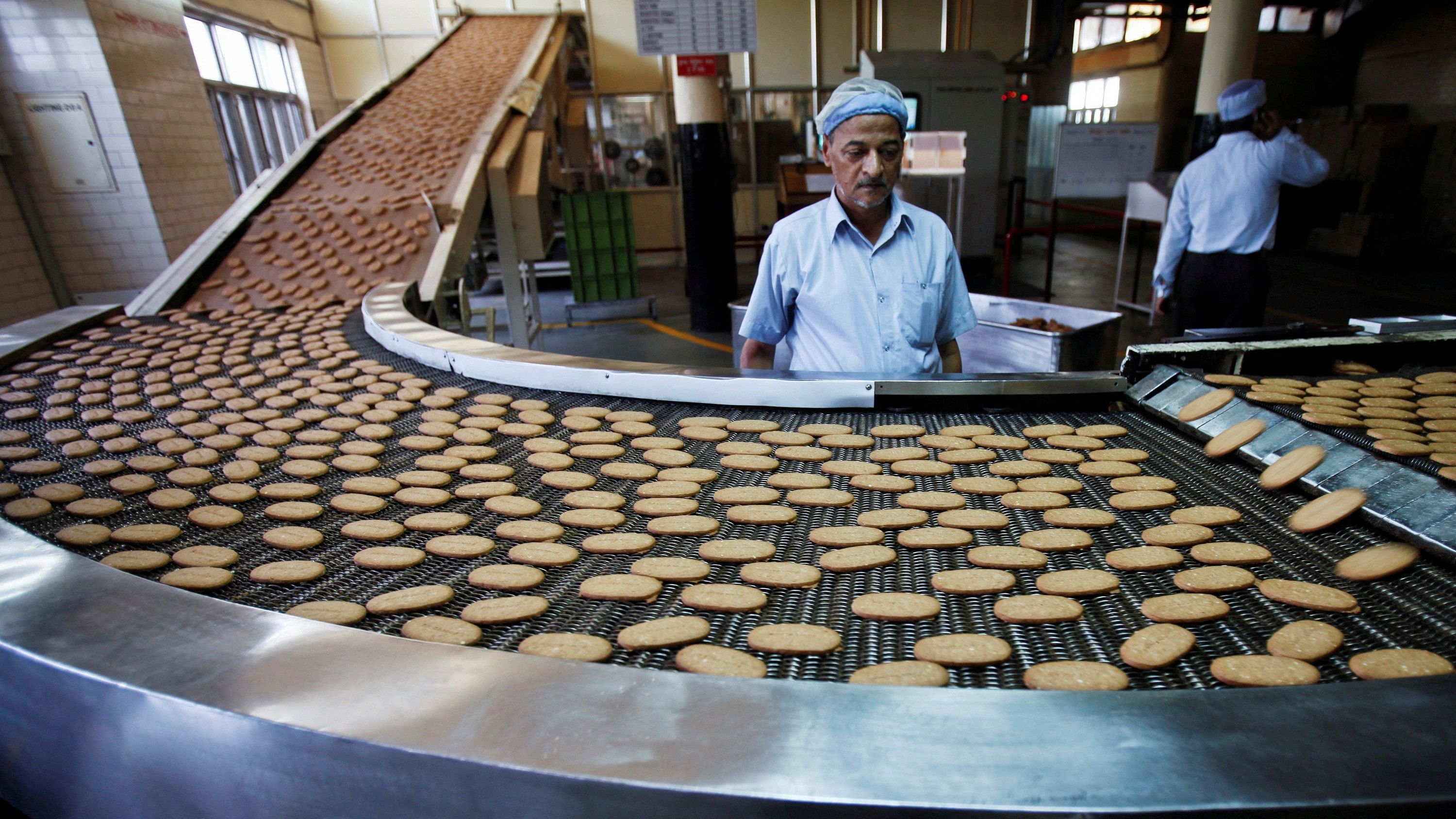 <div class="paragraphs"><p>A worker stands next to a production line at the Britannia biscuit factory in New Delhi.&nbsp;</p></div>