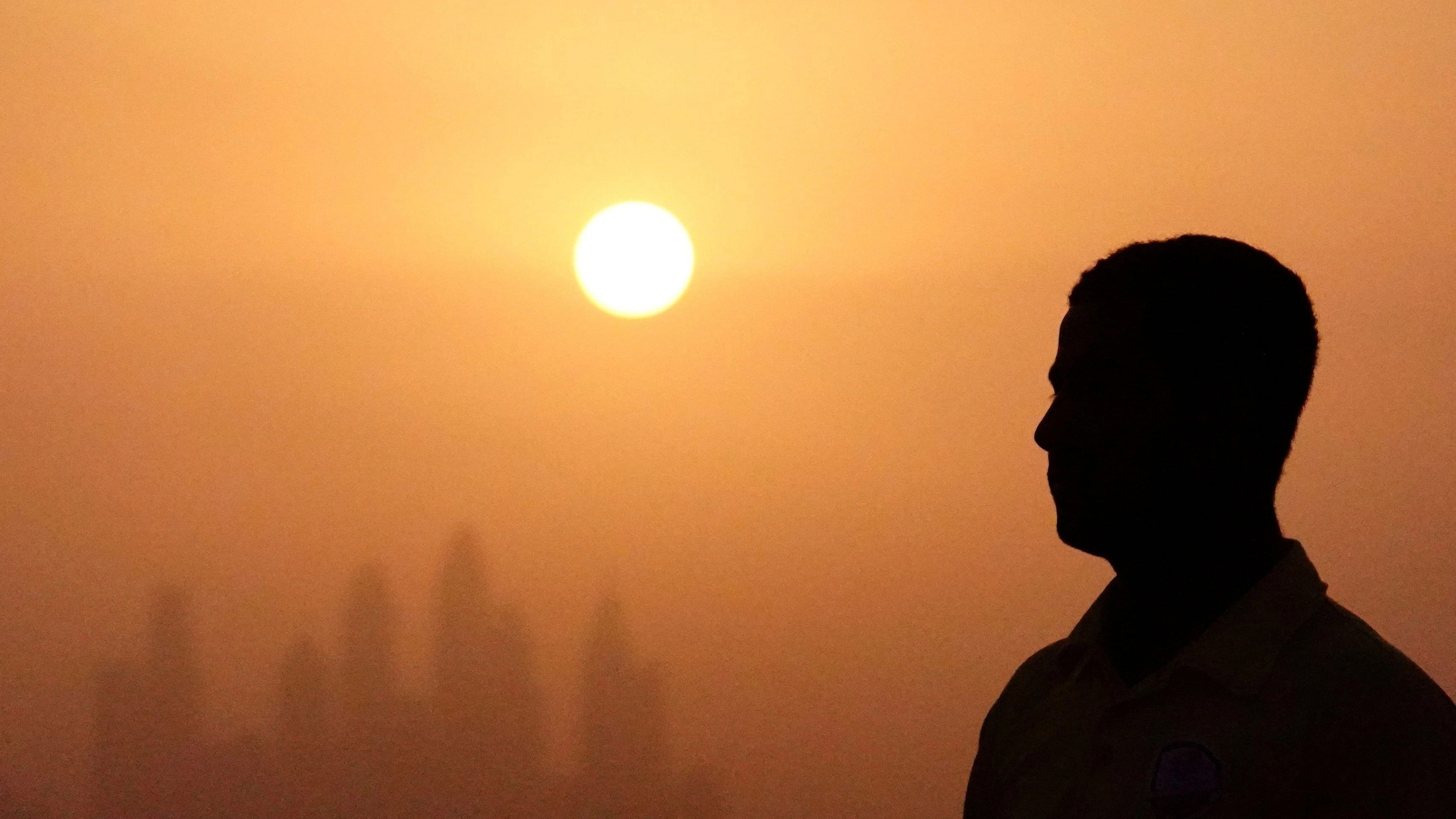 <div class="paragraphs"><p>A man is pictured against the backdrop of the&nbsp;sun setting over Dubai, United Arab Emirates, August 12, 2023</p></div>