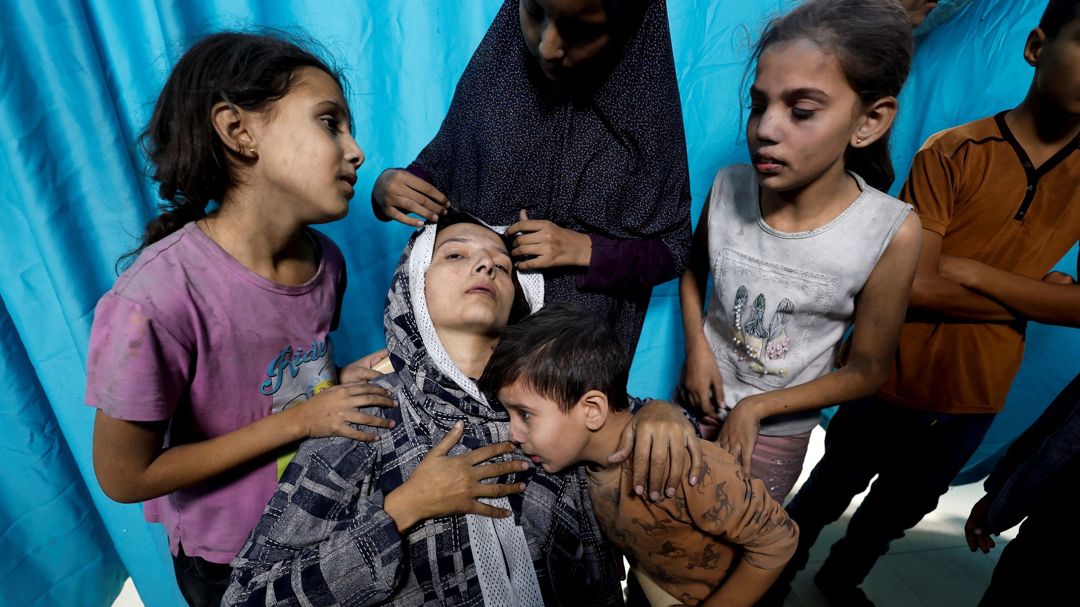 <div class="paragraphs"><p>A Palestinian woman and children react after Israeli strikes, at a hospital in&nbsp;Khan&nbsp;Younis&nbsp;in the southern Gaza Strip, November 13, 2023. </p></div>