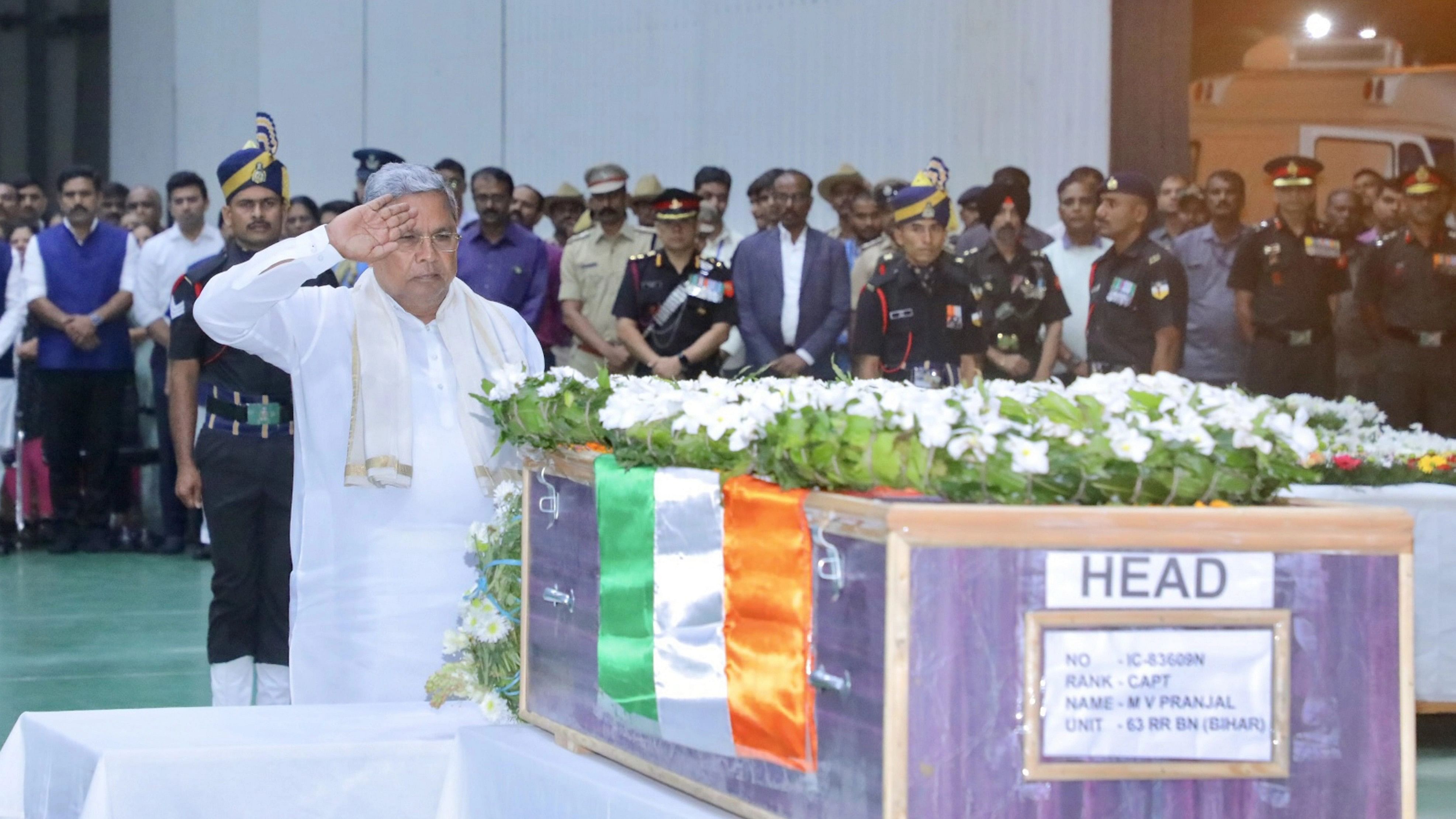 <div class="paragraphs"><p> Bengaluru: Karnataka Chief Minister Siddaramaiah pays tribute to the mortal remains of martyr Captain M V Pranjal who was killed during an encounter with terrorists in Jammu and Kashmirs Rajouri, at HAL Airport, in Bengaluru, Friday, Nov. 24, 2023.</p></div>