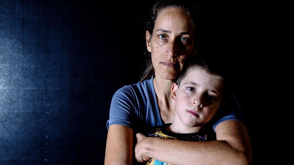 <div class="paragraphs"><p>Nirit Hunwald and her son Nadav, survivors of a deadly infiltration by Hamas gunmen on Kibbutz Beeri, pose for a portrait in a hotel in Ein Bokek, Israel.</p></div>